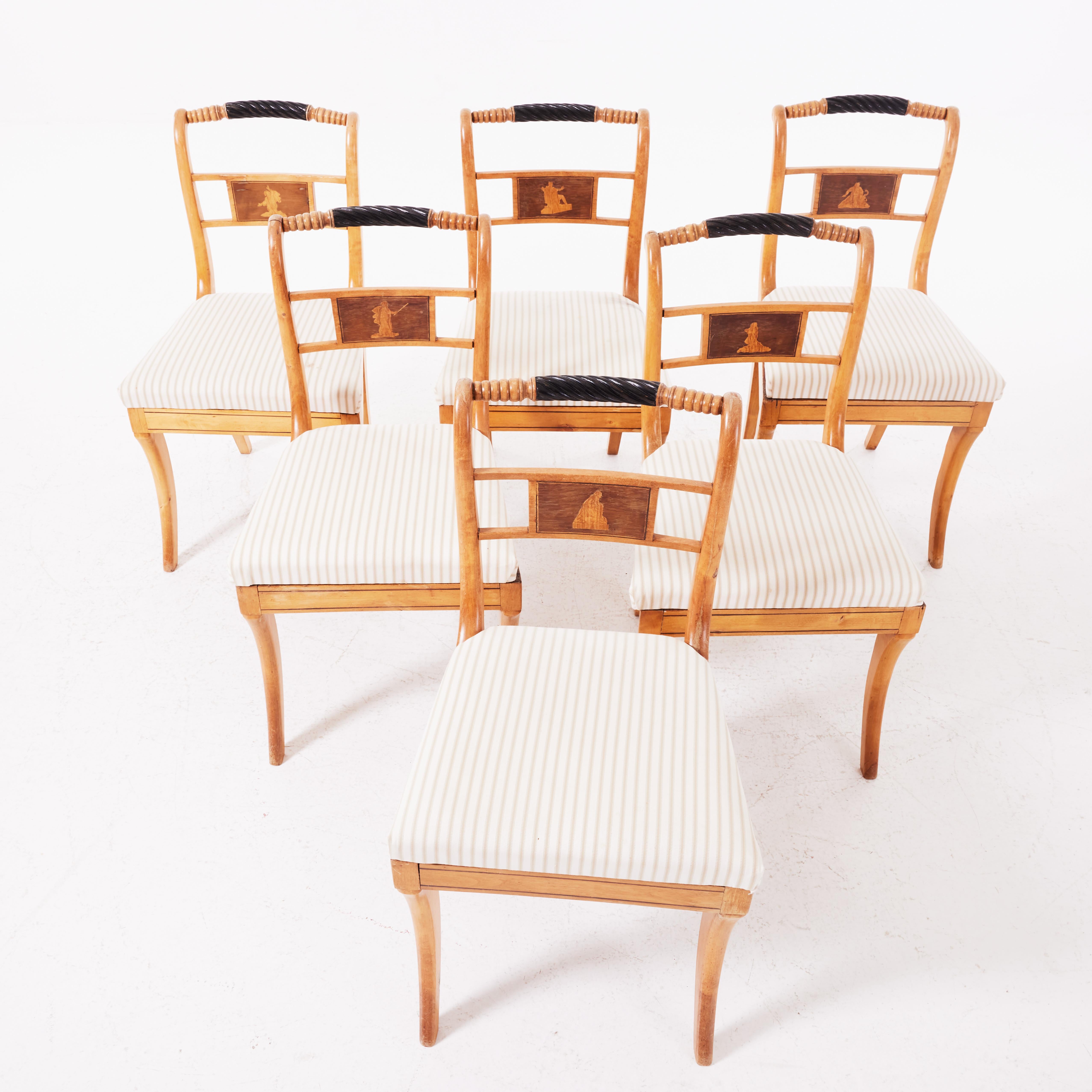 Karl Johan, intarsia decoration with antique figures, blackened turned backrest. The seat upholstered. Very good original condition.
