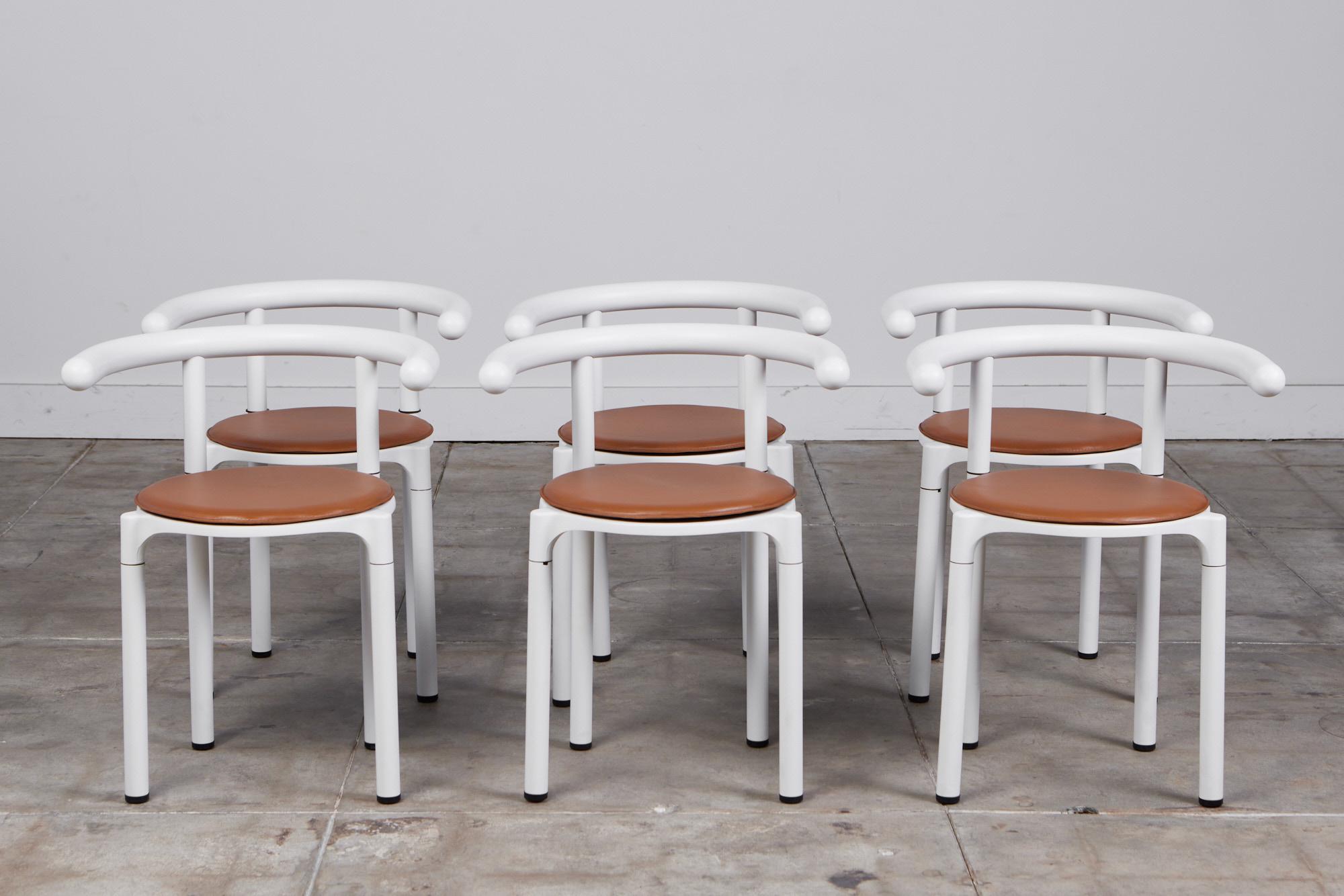 A set of six late modernist dining chairs from Italian design house Kartell. The 4855 model is a rarer edition of seating, designed in 1981 by the company’s co-founder and Art Director, Anna Castelli Ferrieri. Each chair has a round leather seat on