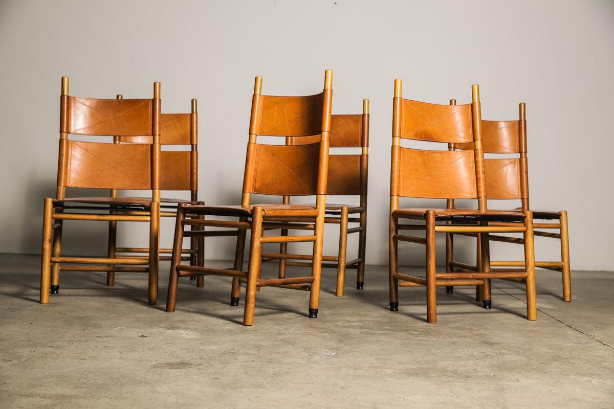 Set of six “Kentucky” chairs designed by the Master of Design; Carlo Scarpa for Bernini in 1977. Made from oak and walnut timer the chairs retain the original black leather seat and backrest with saddle stitching. Scarpa was inspired by the “Shaker”