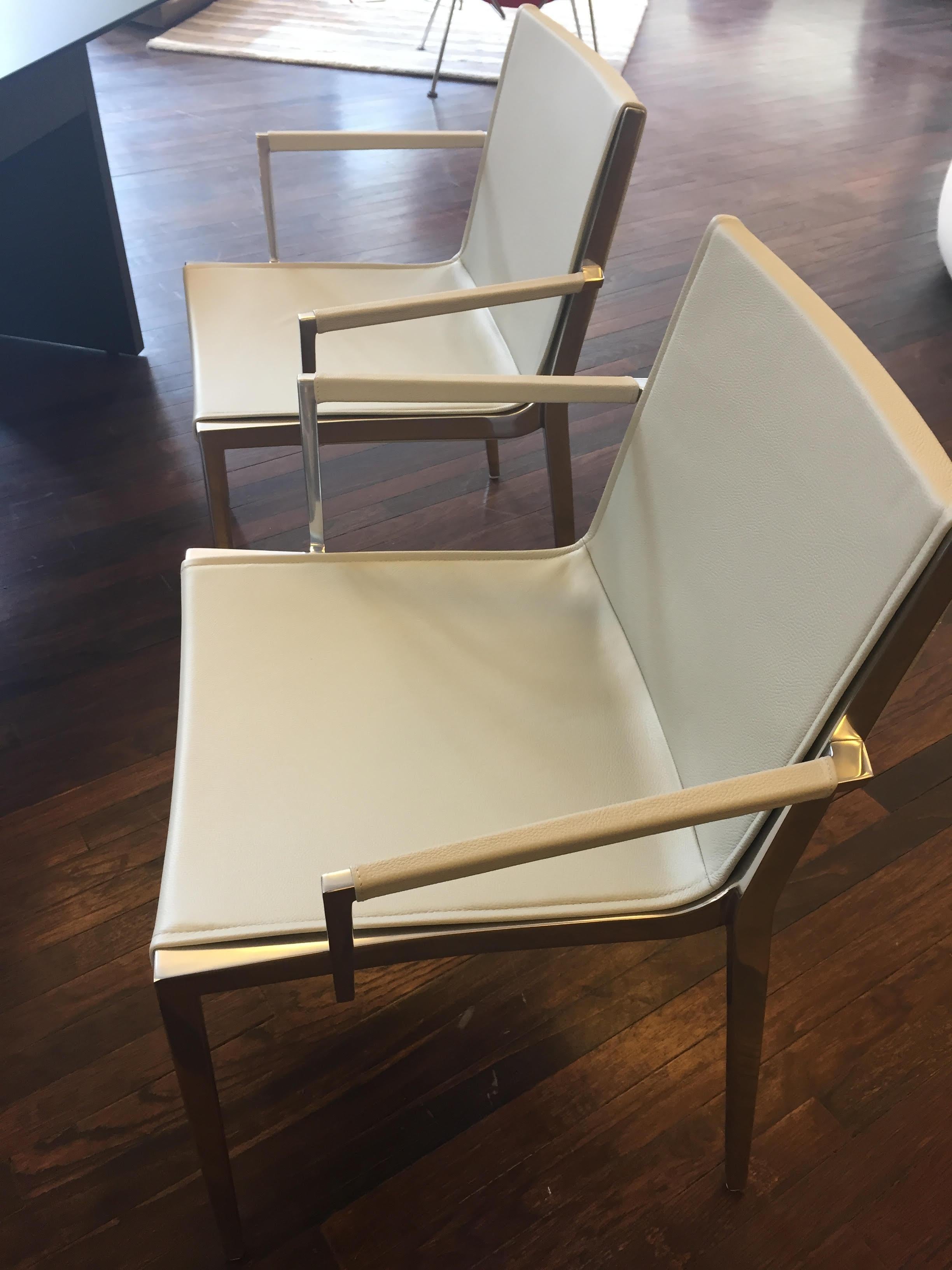 Six unique chairs
2 armchairs and 4 brown leather side chairs.

Upholstered in leather
Frame: Polished aluminum
Glides: For hard floors
The unique program comprises chairs and tables. A flexible backrest and the soft seating area make