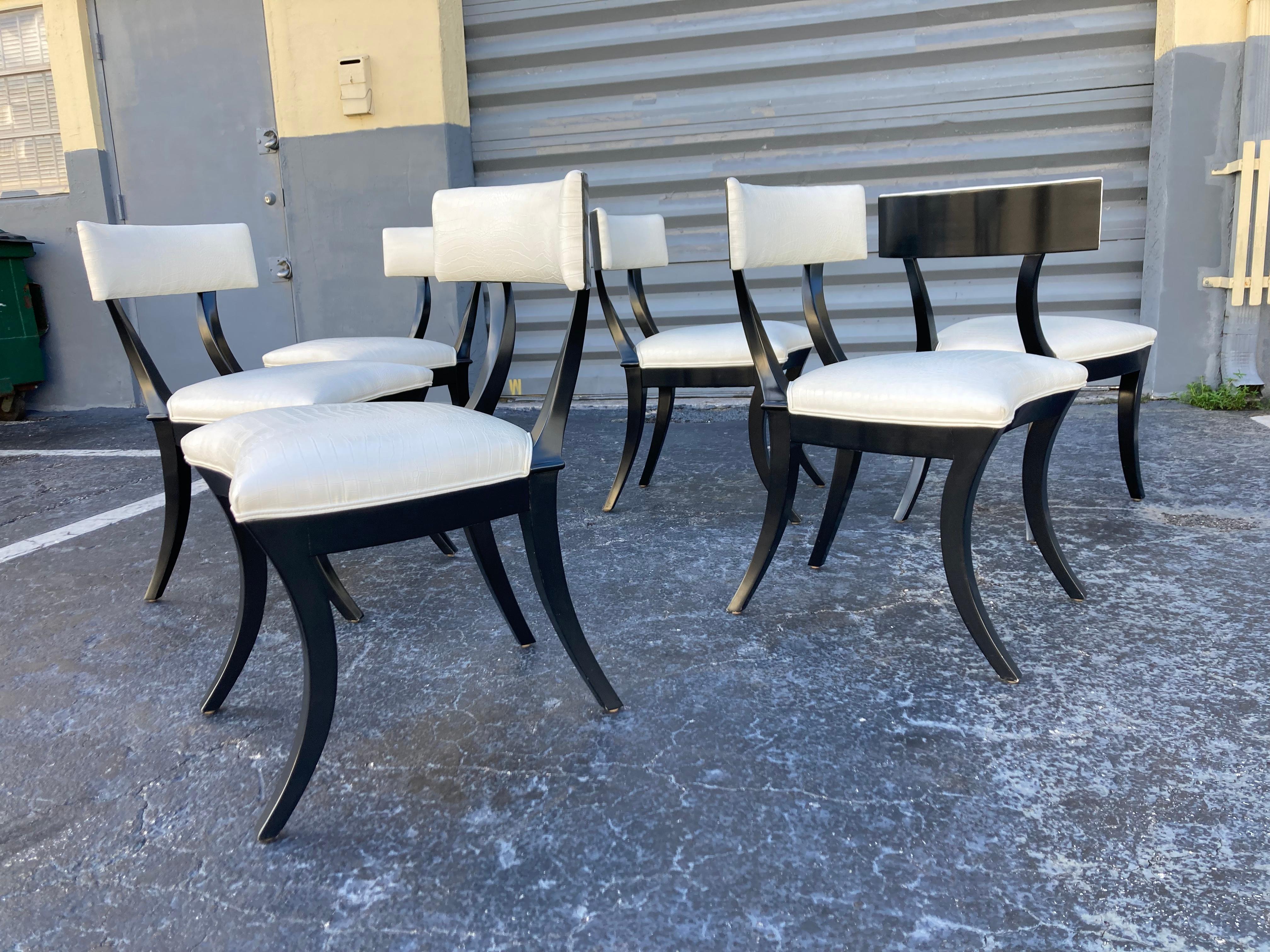 Exceptional set of six Olympia Klismos dining chairs made by Artistic Frame NY. Ebonized wood with white embossed crocodile leather seats and backs. 
Exceptional quality and great design.
The set is not new and it does have some normal age related