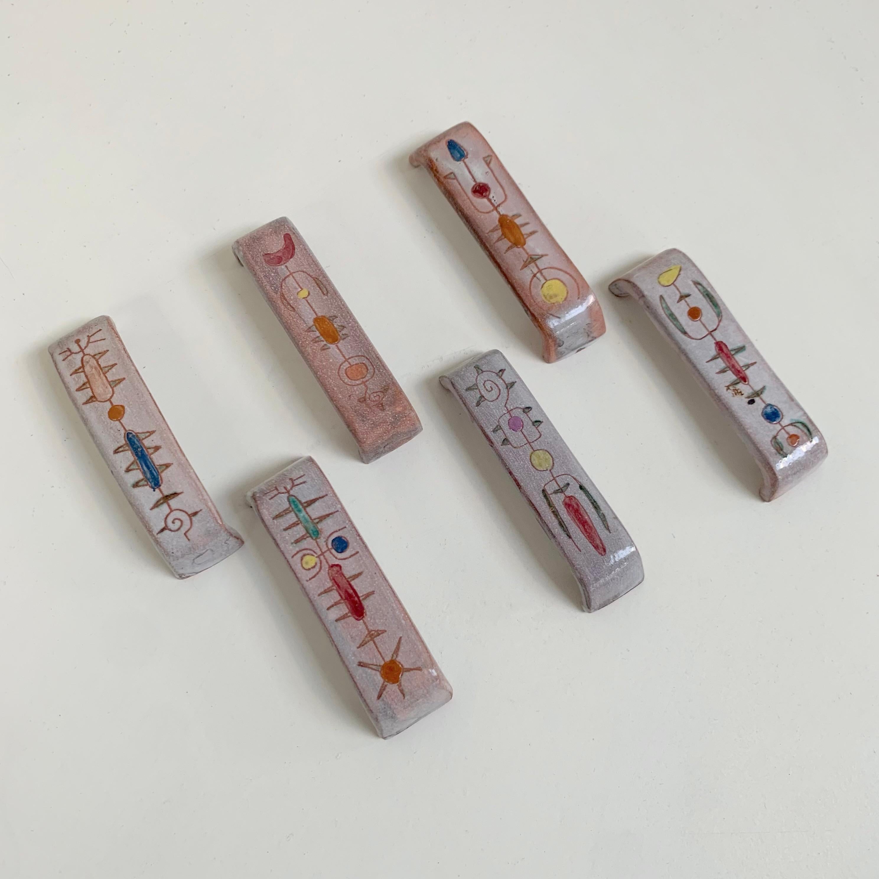 Set of six ceramic knife-holders by Jean Rivier, circa 1960, Vallauris, France.
Hand-painted and enameled ceramic, signed Jean Rivier underneath.
Each pattern is different and unique.
Dimensions: 10cm W (3,93 in), 2,5 cm D (0,98 in), 2 cm H (0,78