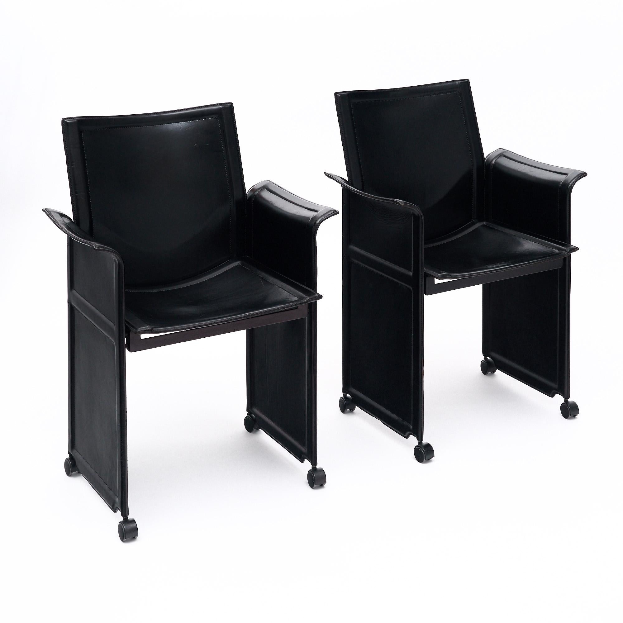 Set of six armchairs by Tito Agnoli designed for Matteo Grassi in 1979. These Italian chairs feature a metal frame and high-quality stitched leather in a black tone. They are very comfortable and stable. We especially love the beautiful stitching on
