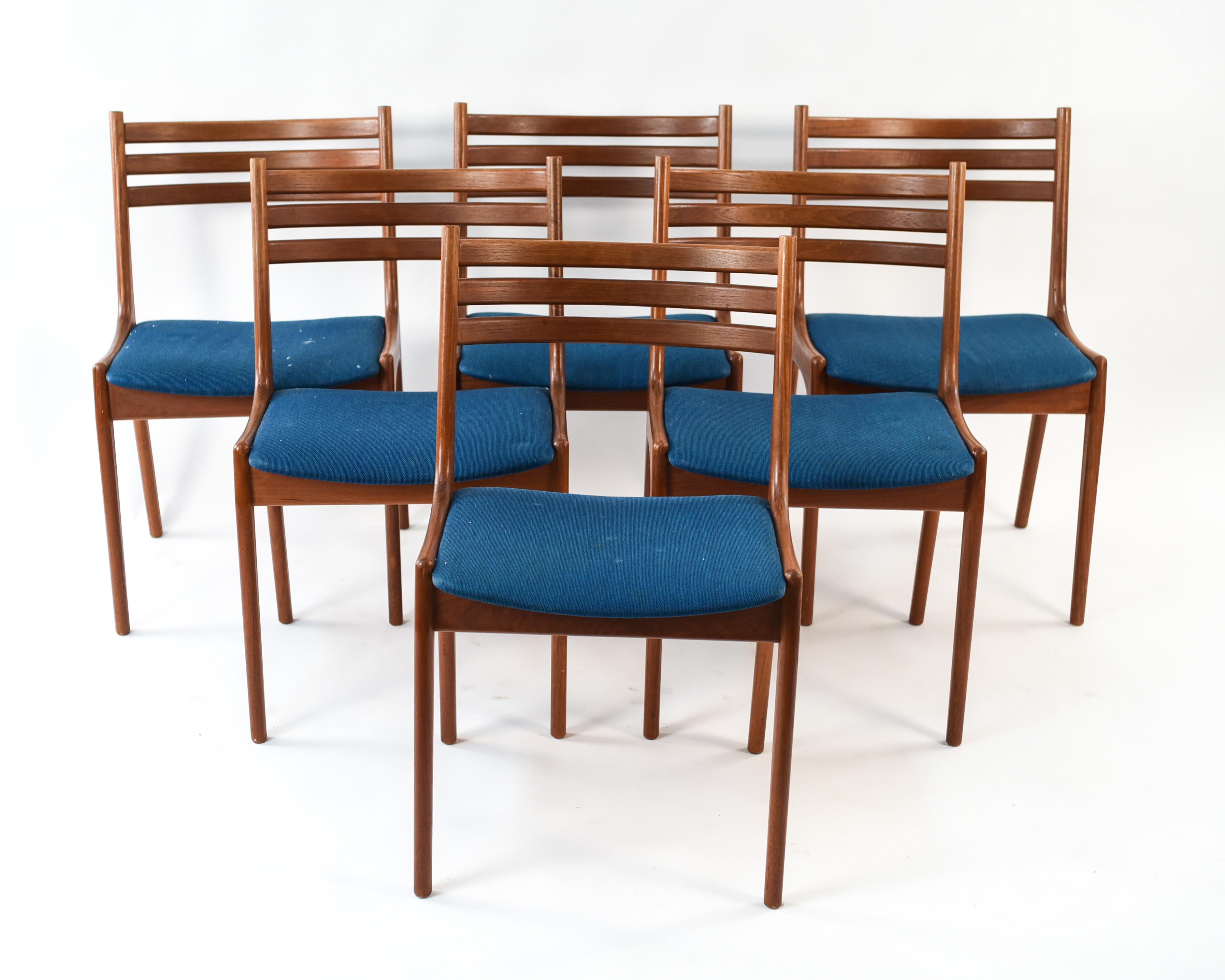 This is a great set of six teak dining chairs produced by K.S. Mobler. This design is attributed to Kai Kristiansen and features a rounded slat back with a slim frame throughout.