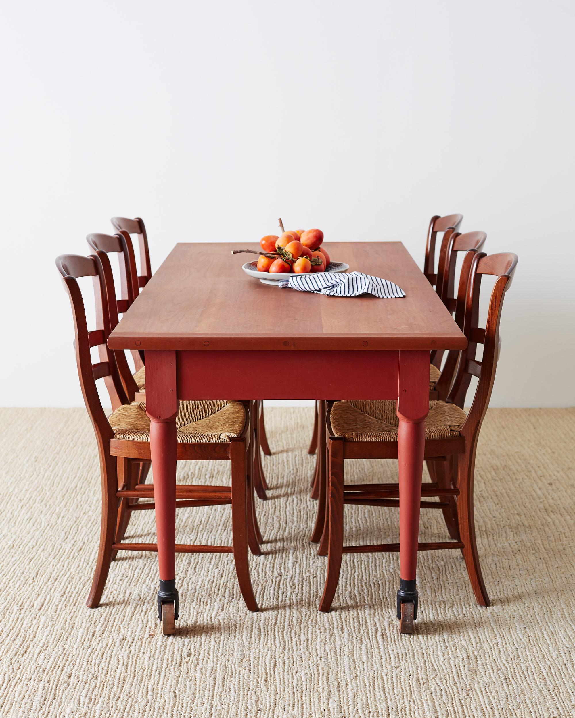 Country style set of six ladder-back dining chairs featuring a hand-woven rush seat. Contemporary chairs made with an ergonomic curved back and a distinct vintage profile. Finished in a rich stain to accent the lighter woven seat.
