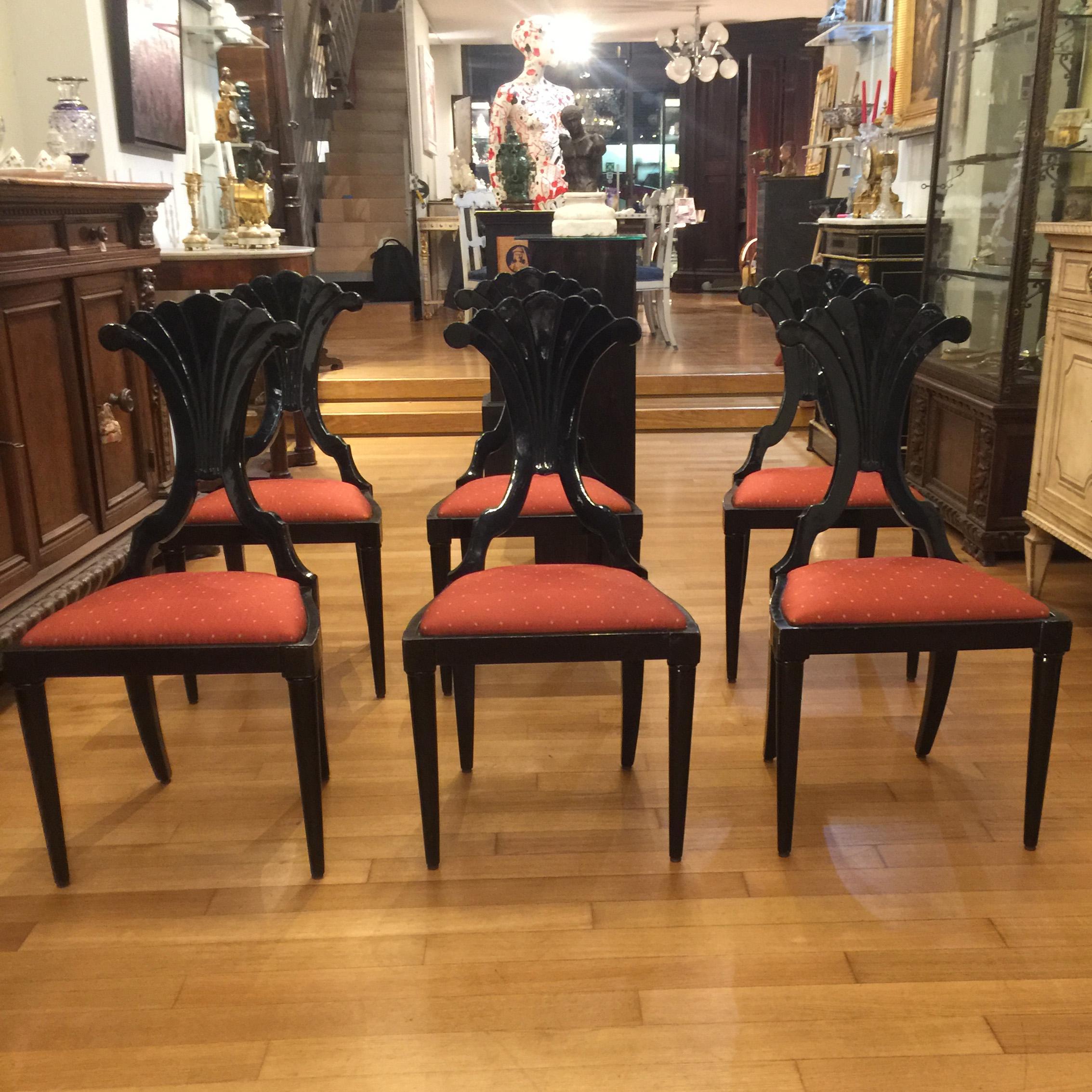An elegant set of six Italian Bidermeier style chairs in solid black wood. The chairs present a beautiful Silhouette with elegant lines, a loop with ormolu detail underneath the curved back and straight legs.