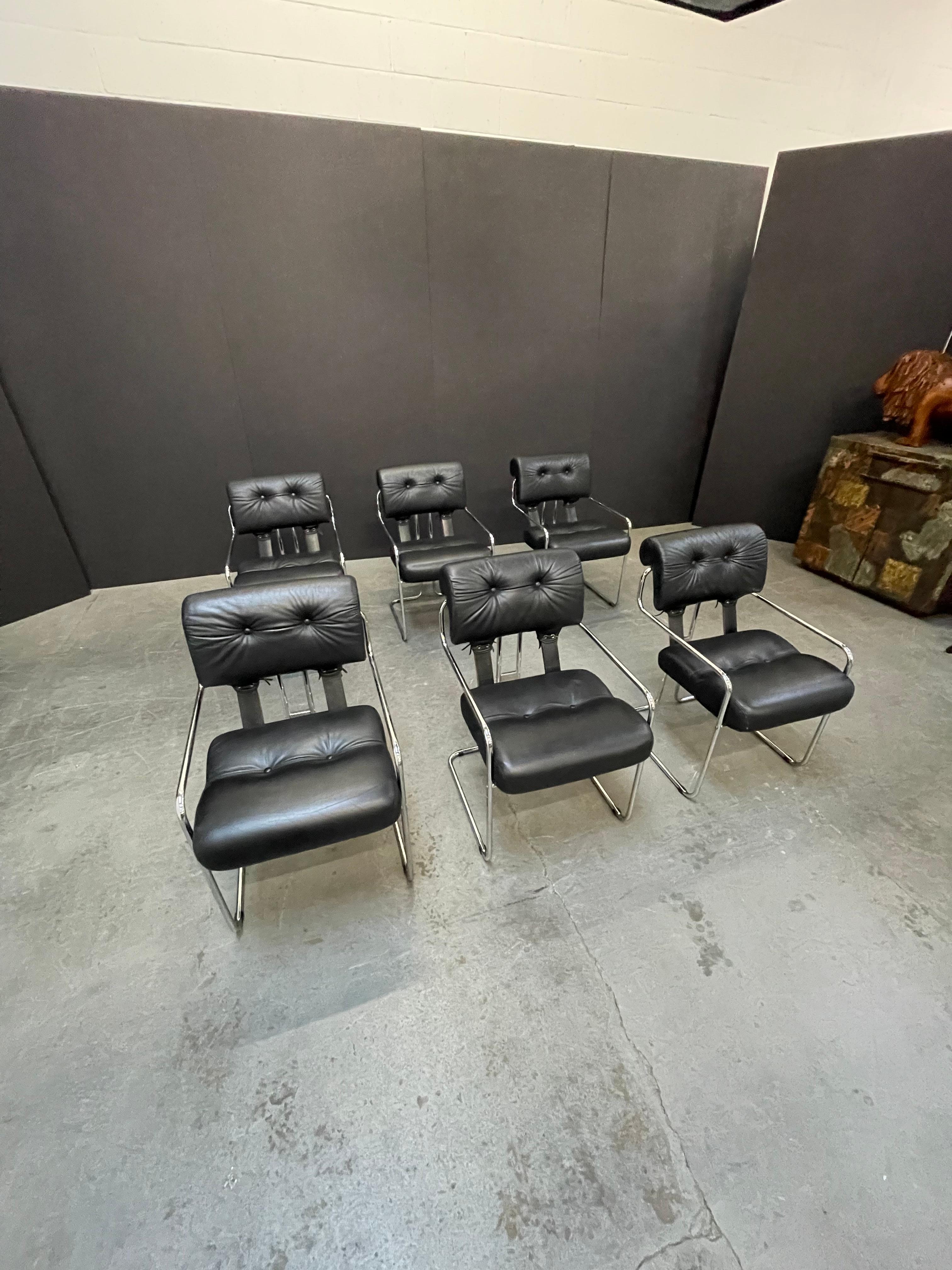 Currently, the most coveted dining chairs by interior designers are 'Tucroma' chairs by Guido Faleschini for i4 Mariani, and we have this incredible set of six (6) Tucroma armchairs in beautiful black leather with polished chrome frames. The seats