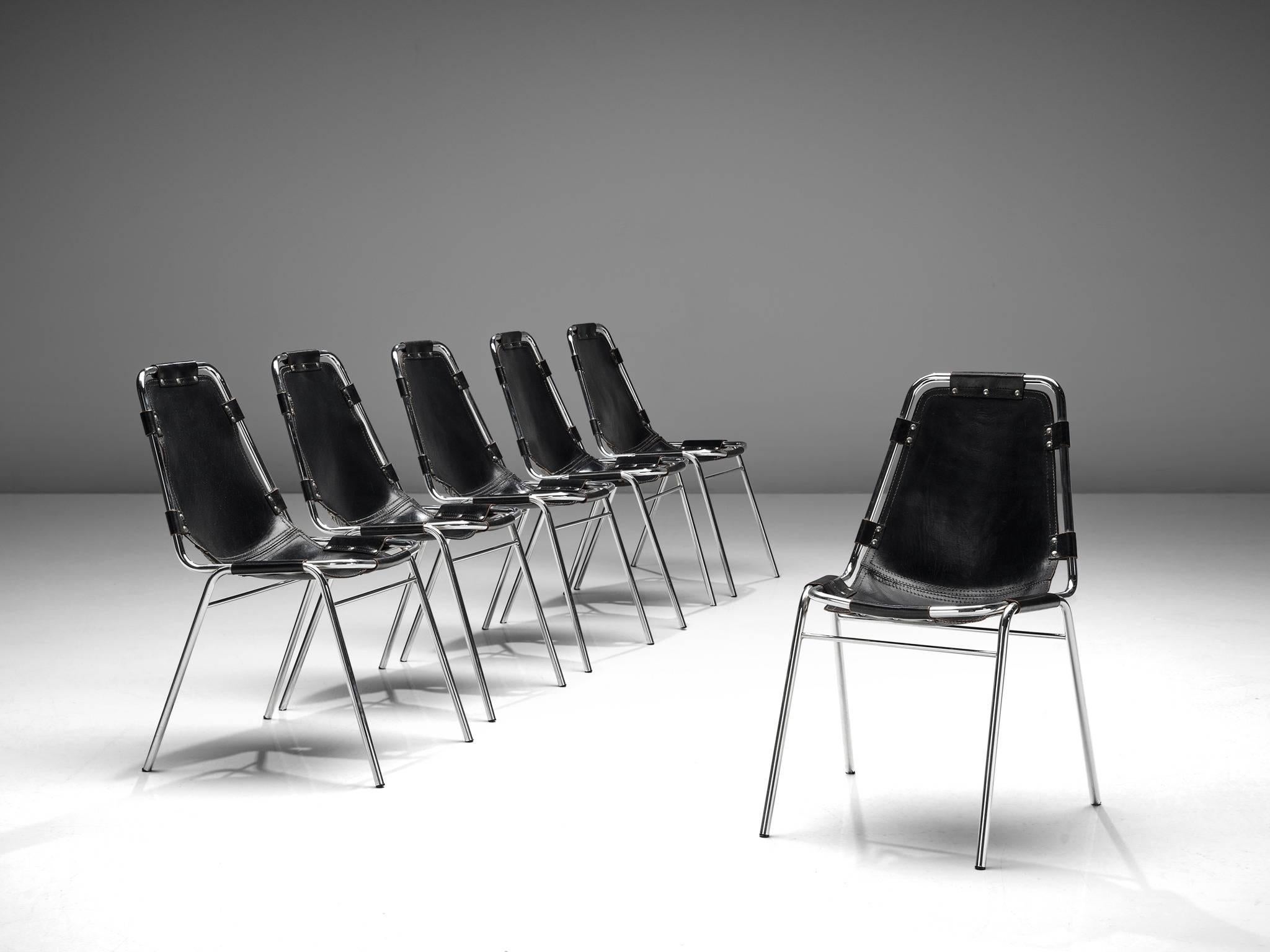 Set of six chairs, in steel and black leather, France, circa 1970s. 

Set of six chairs of the famous model 'Les Arcs.' The simplistic design consists of a tubular steel frame with a seating of thick black saddle leather. The natural leather makes
