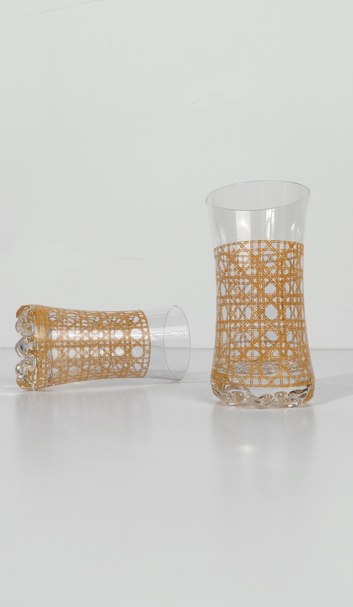  We're offering for sale a set of glamorous and highly decorative 1970s tumblers.
Each of the six cocktail glasses, which we might identify as Highball glasses, is decorated with a decal reproducing the Rattan Cane Webbing motif.
Perfect for serving