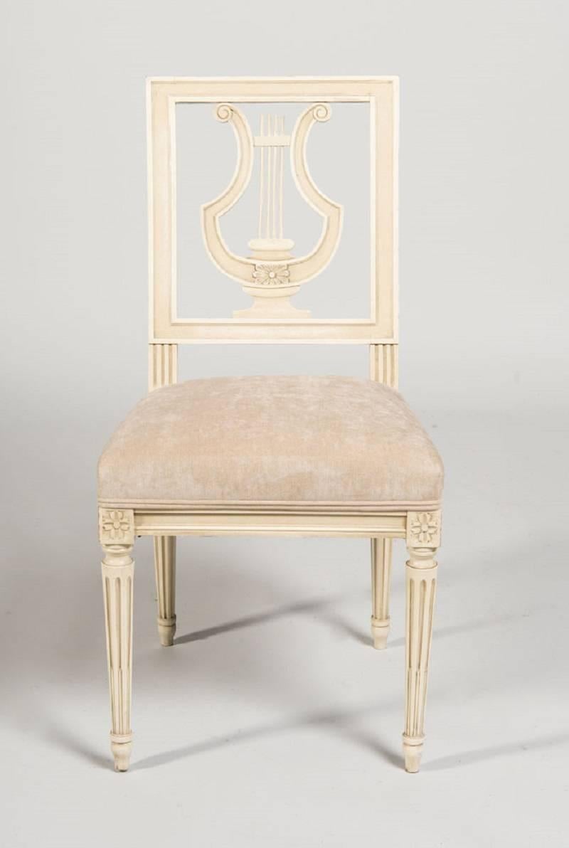 A fine set of French Louis XVI style dining chairs by Maison Jansen. The chairs are cream painted with elegant neutral beige upholstery.

 