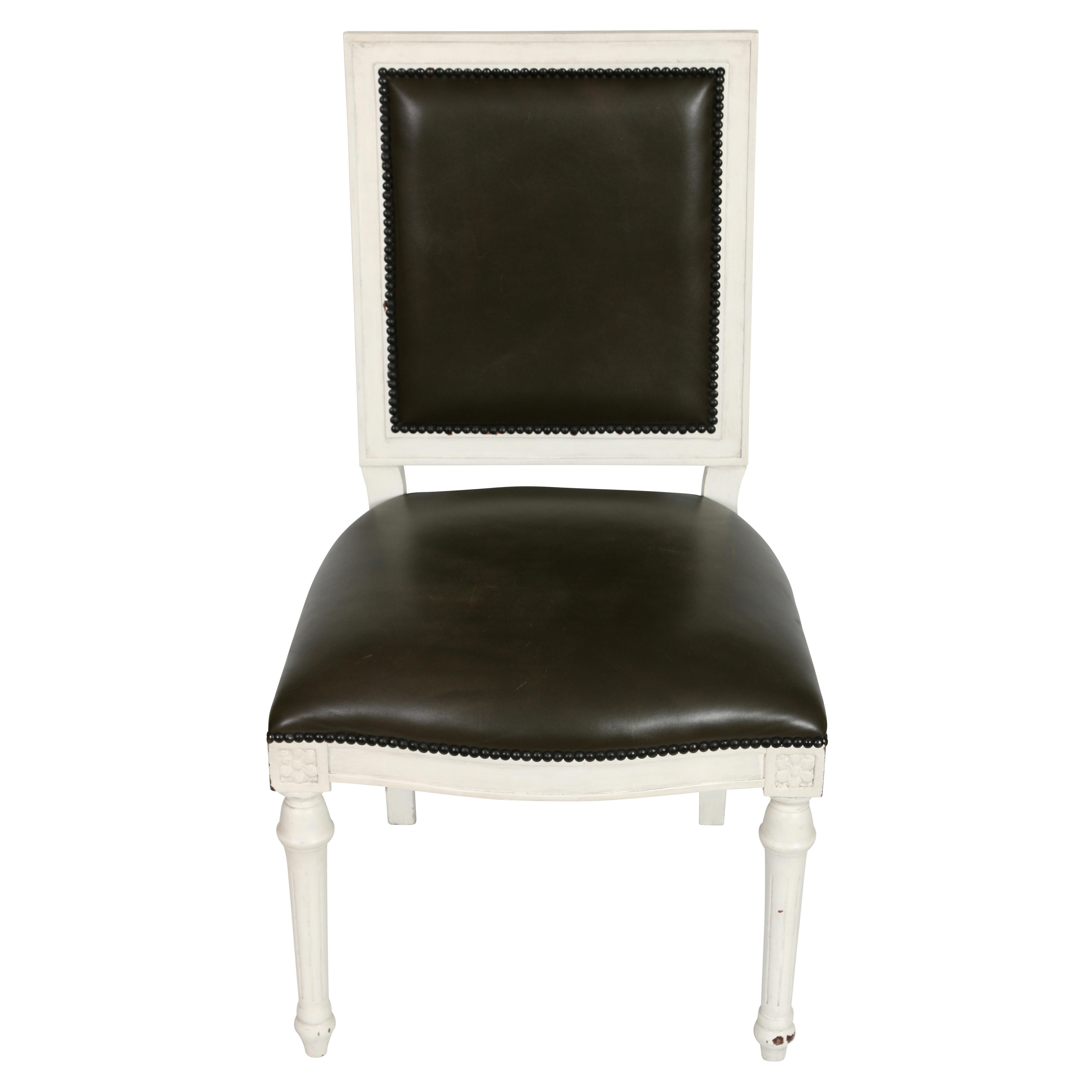 The striking contrast between the chalky white painted finish and the deep, chocolate brown leather upholstery is what makes these chairs so good looking. The chairs feature a squared back and a slightly curved seat and are finished with a nail head