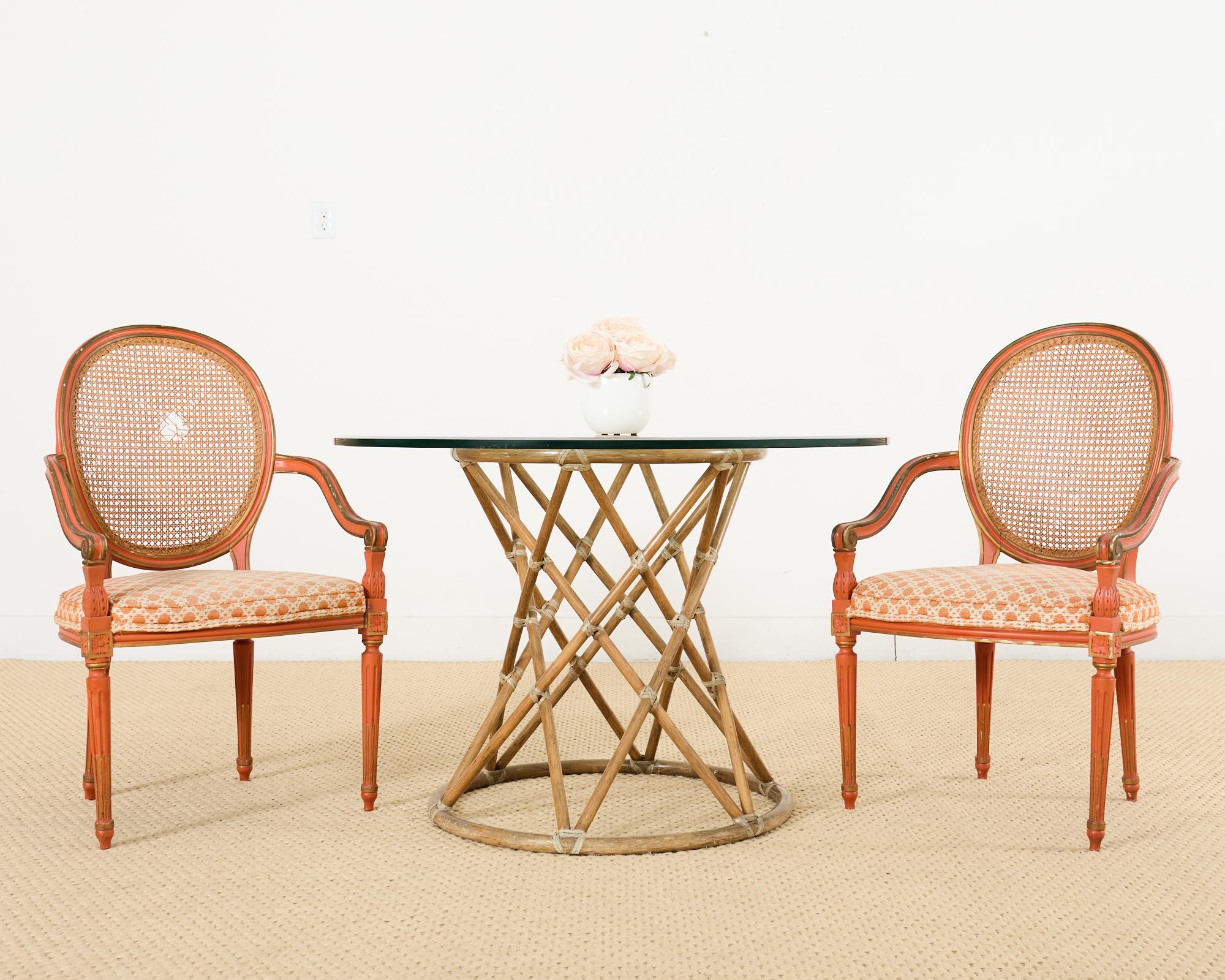 Whimsical painted set of six French dining chairs crafted in the Louis XVI taste. The set consists of four side chairs and two host armchairs measuring 23 inches wide and deep. The carved beechwood frames have an oval cameo or balloon back inset