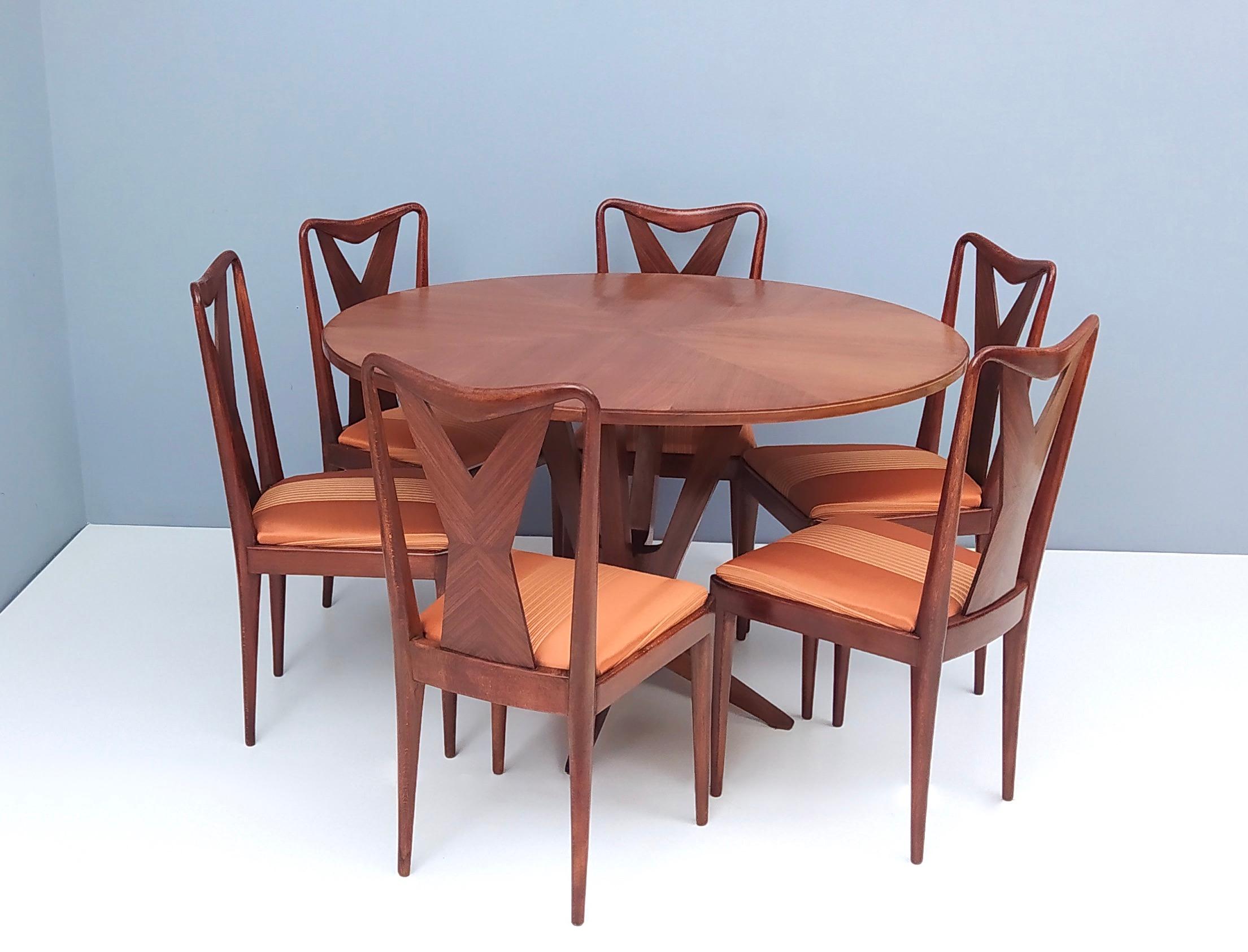 Made in Italy, 1950s.
Their design is ascribable to Ico Parisi, in particular the shape of the legs.
These dining chairs feature a walnut frame and a new orange satin upholstery.
They're vintage therefore they might show slight traces of use, but