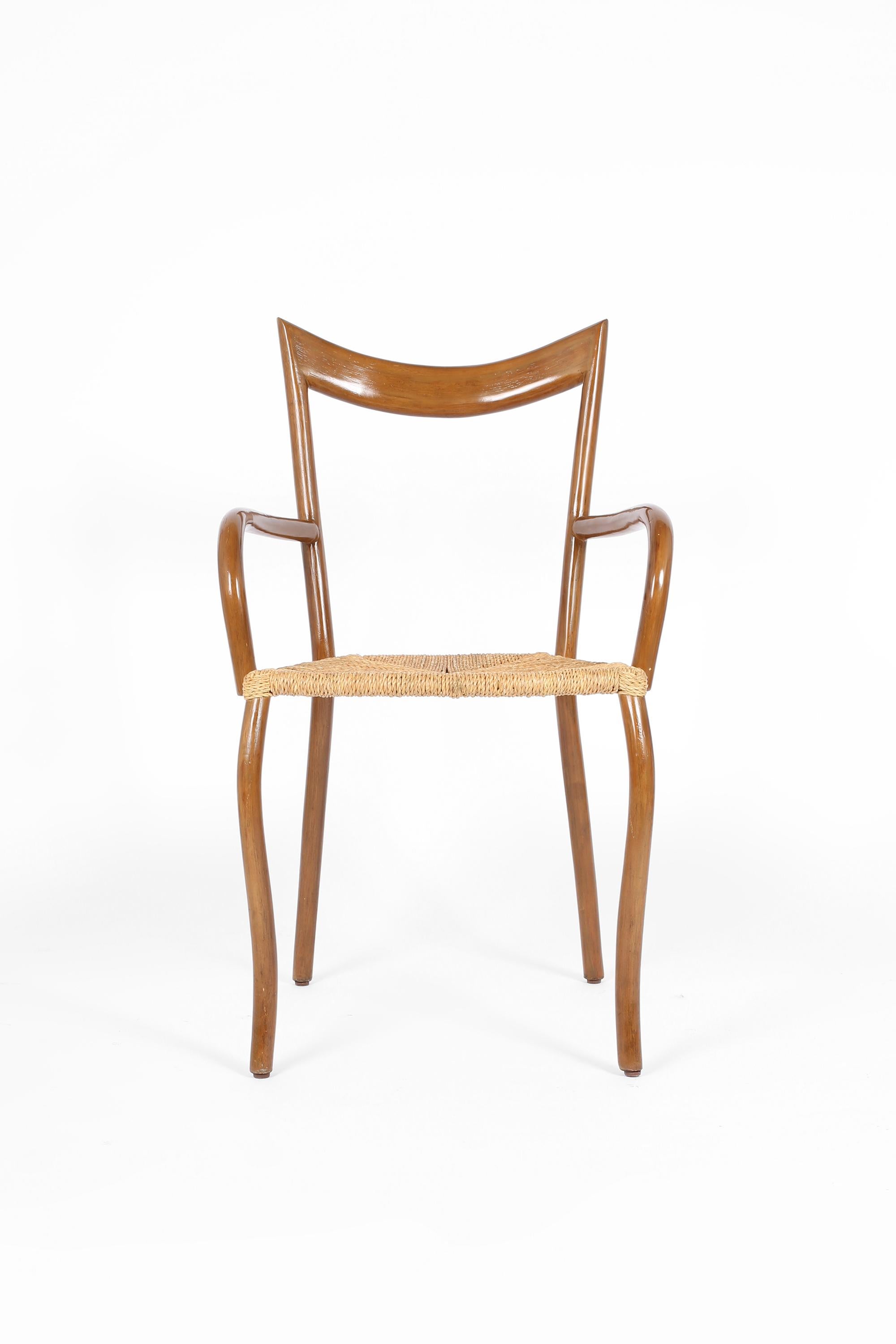 A rare set of six ‘Manila’ carver dining chairs by Filipino designer Val Padilla. The shapely varnished wooden frame features a steel inner core, with seats woven in seagrass. Retailed in the UK by Conran, c. 1980s.