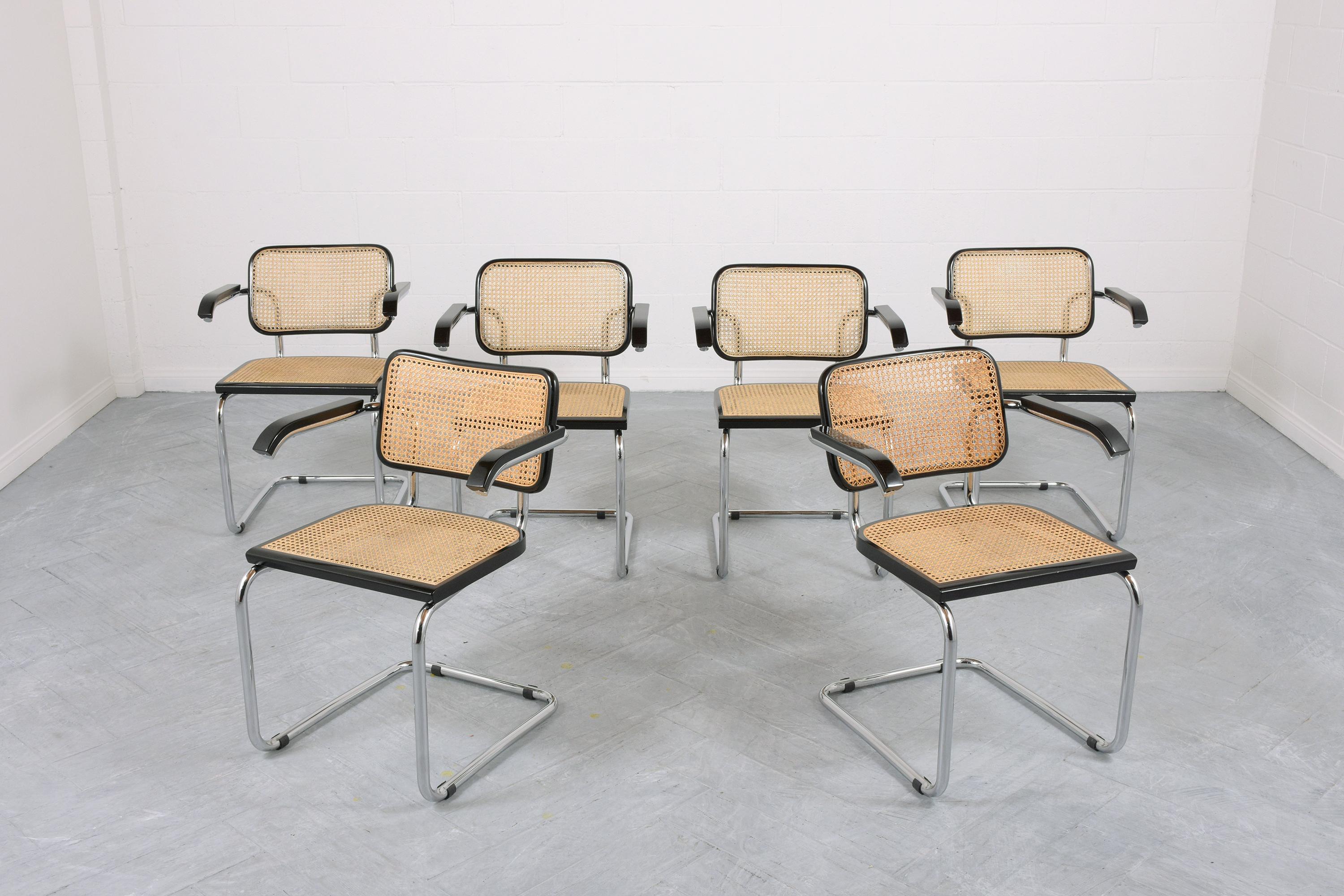 This set of six mid-century dining chairs by Marcel Breuer Cesca is in great condition and is hand-crafted out of steel and wood newly restored by our professional craftsmen team. These vintage dining chairs are eye-catching and feature sleek chrome