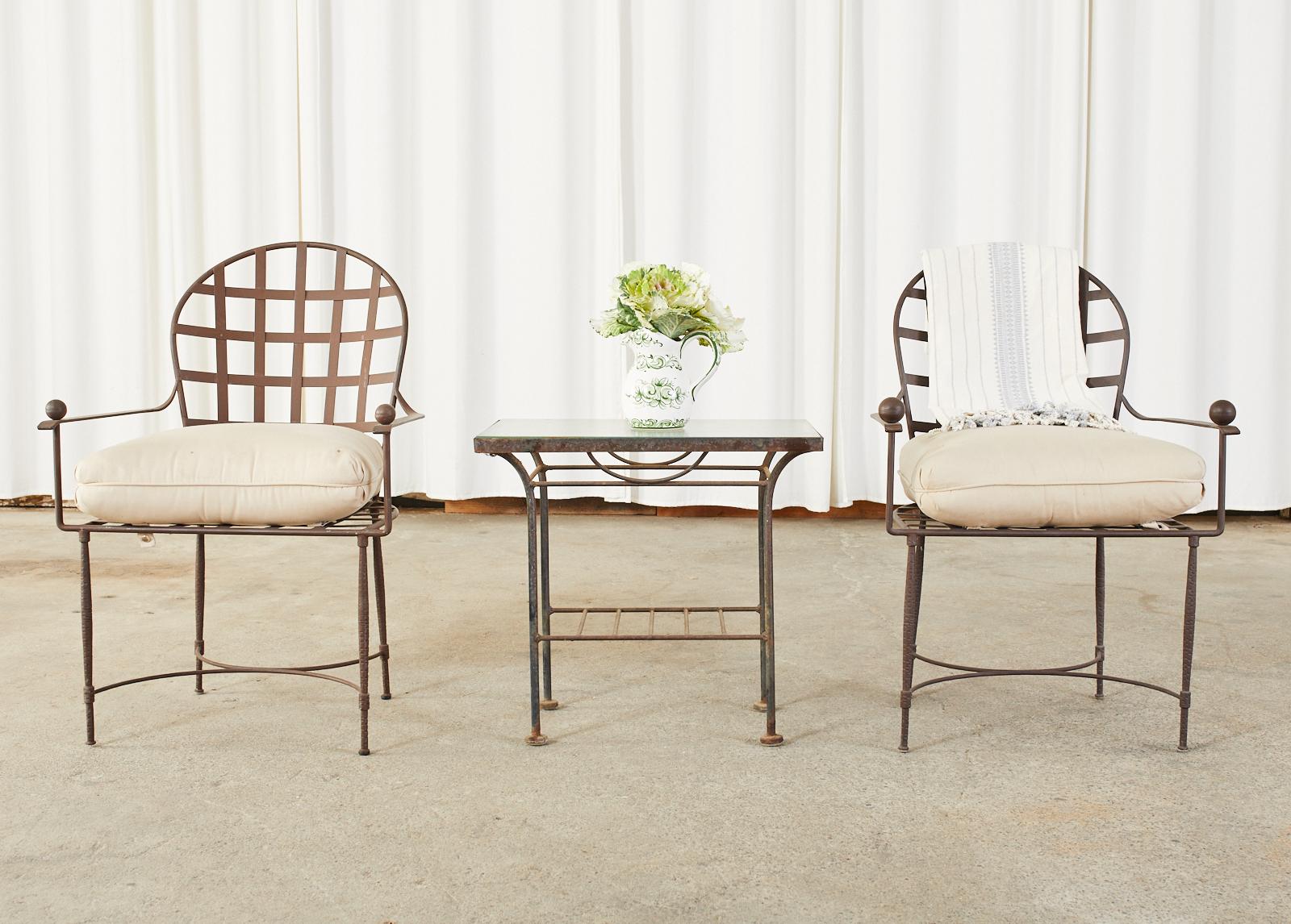 Iconic set of six iron patio and garden dining armchairs designed by Mario Papperzini for John Salterini. Mid-century modern design features hand-hammered iron frames with a gracefully curved crest rail and flat arms ending with ball finials. The