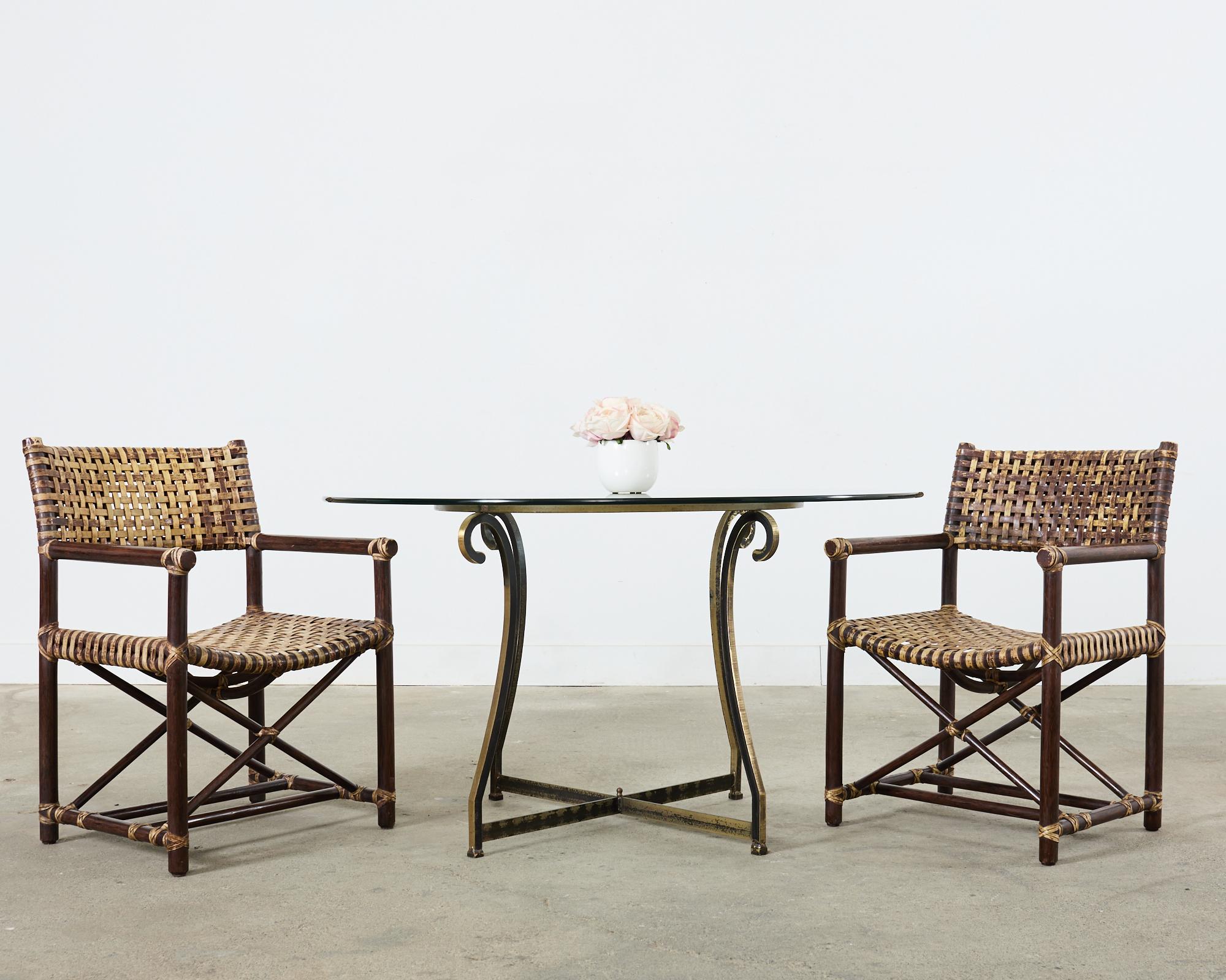 Distinctive set of six laced leather rawhide and rattan dining armchairs made in the California coastal organic modern style by McGuire. The Antalya armchairs (Model #MCLM45) feature rattan pole frames reinforced with woven leather rawhide laces