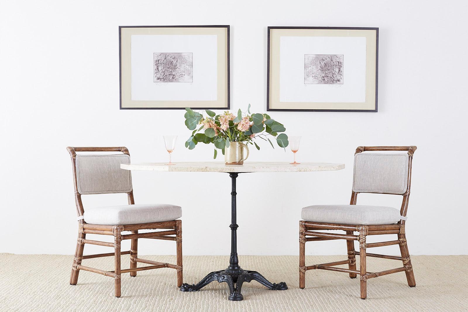 Fabulous set of six genuine McGuire bamboo rattan dining chairs made in the organic California Modern style. Featuring new organic linen upholstery handcrafted by McGuire artisans. The rattan frames feature abundant leather rawhide laces on the