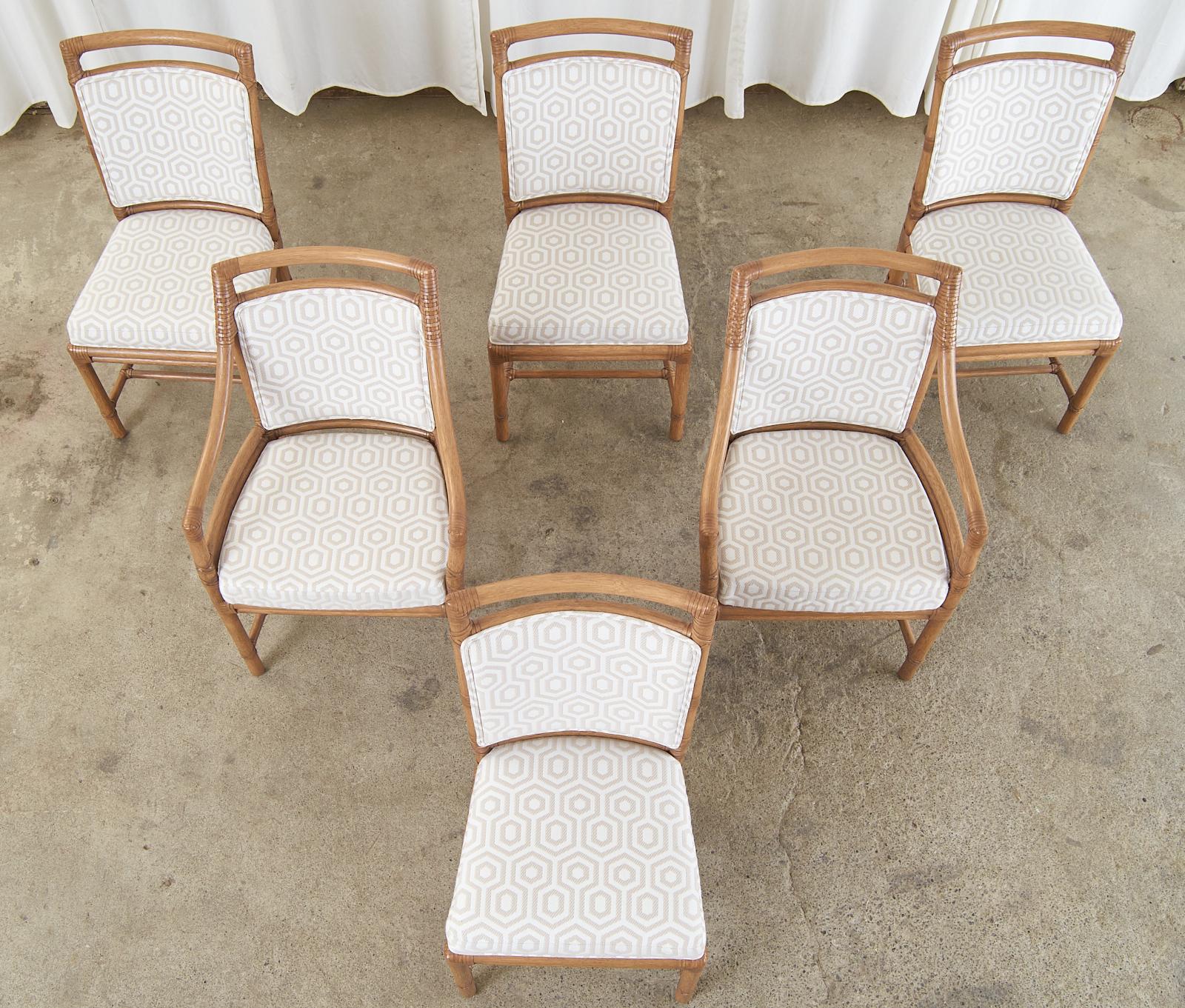 Spectacular set of six McGuire organic modern rattan dining chairs consisting of four side chairs and two host armchairs measuring 24 inches wide. The iconic target chair was designed by Elinor McGuire and is still in production today. The rattan