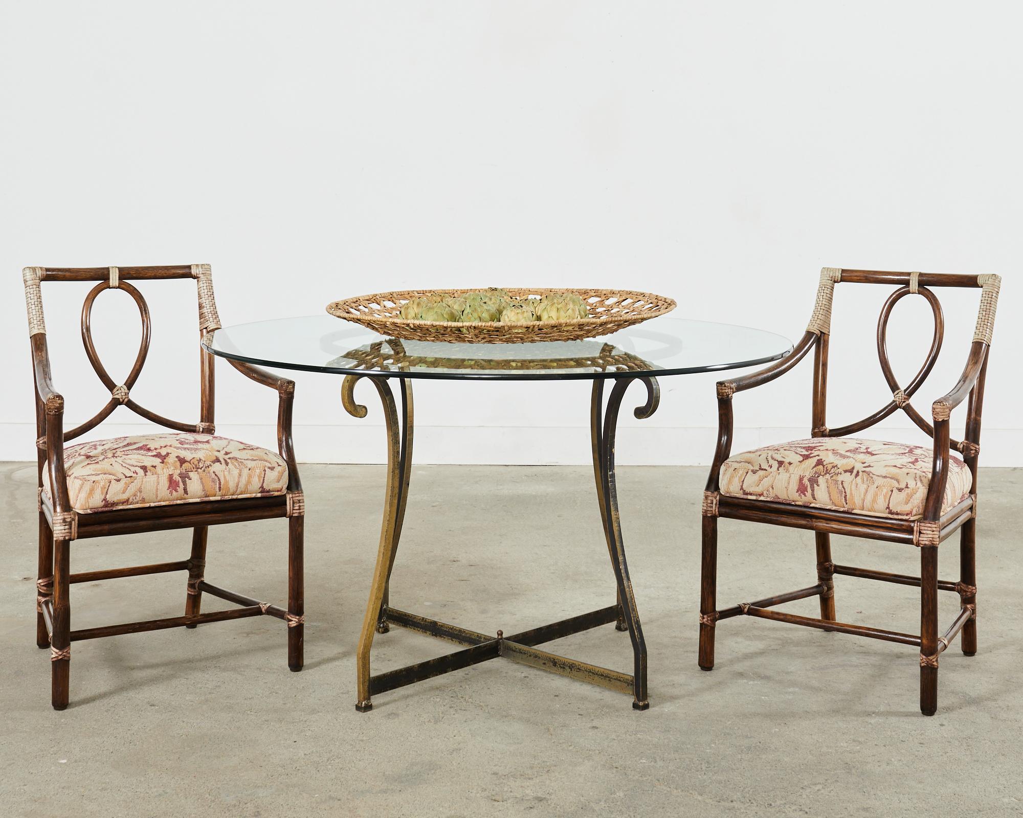 Distinctive set of six McGuire loop-back dining armchairs made in the California coastal organic modern style by McGuire. Designed by Elinor McGuire in the 1970s the Leona loop chair is one of their most iconic and beautiful styles. The rattan