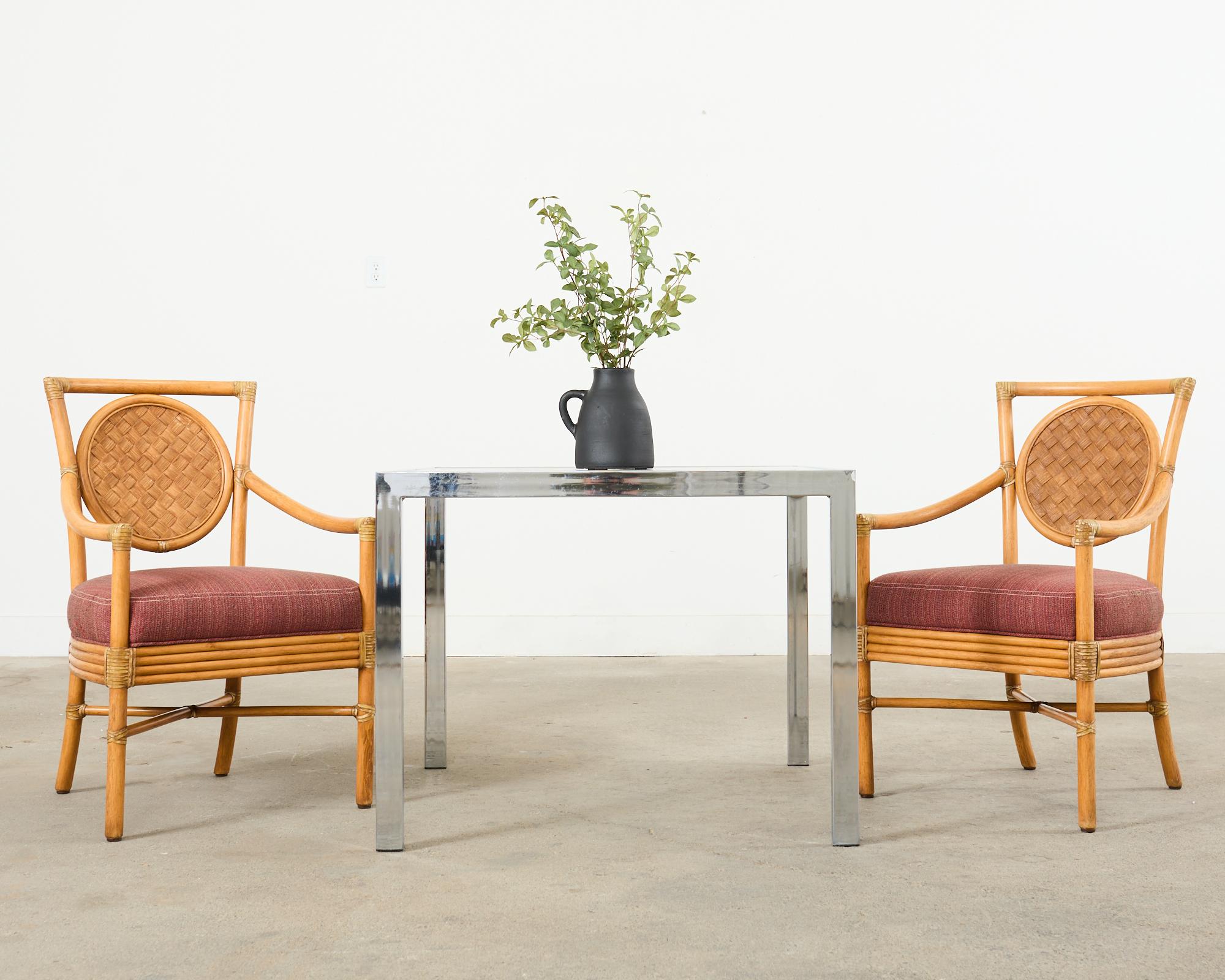 Rare set of six salon dining armchairs (model #MCM222B) designed by Orlando Diaz-Azcuy for McGuire. Made in the California coastal organic modern style with a natural finish on the rattan. The frames have a distinctive square back inset with a round