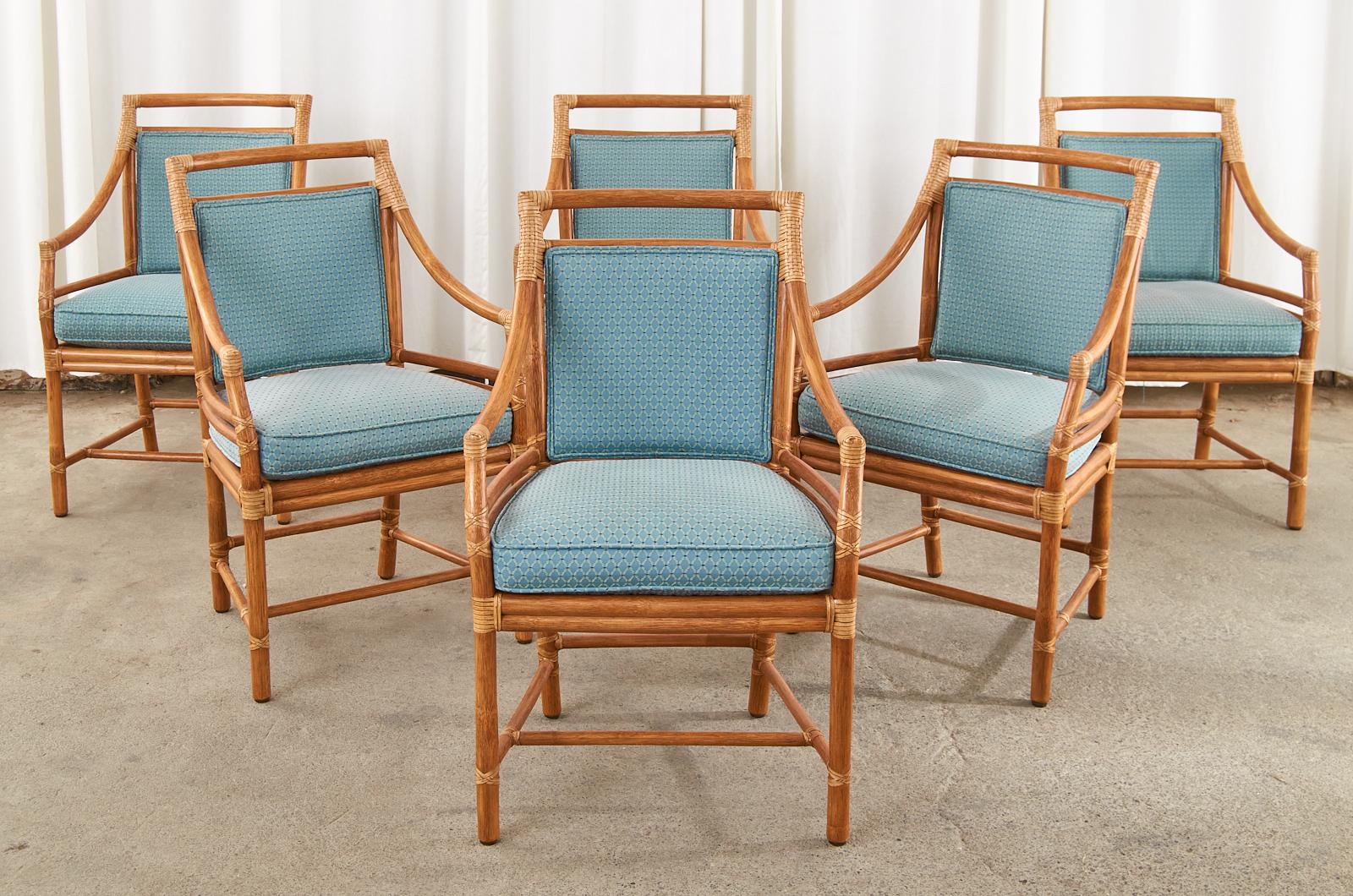 Extraordinary set of six rattan dining armchairs made in the California organic modern style by McGuire. Model number #MCM59B chairs were designed by John McGuire feature a rattan frame with a square back having his signature bullseye target design.