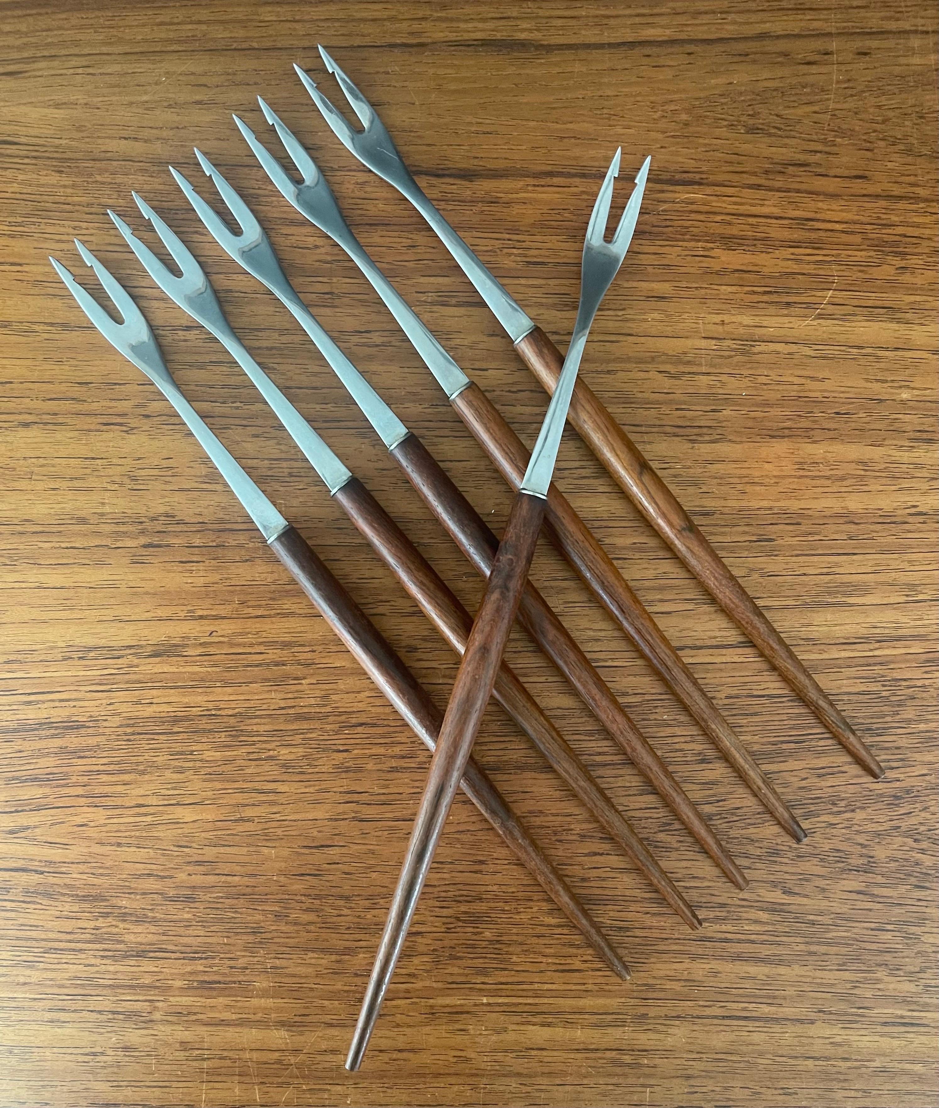 A nice Set of six MCM walnut and stainless steel fondue forks by Rostfrei of Germany, circa 1970s.  The set is in very good vintage condition and each fork is 12