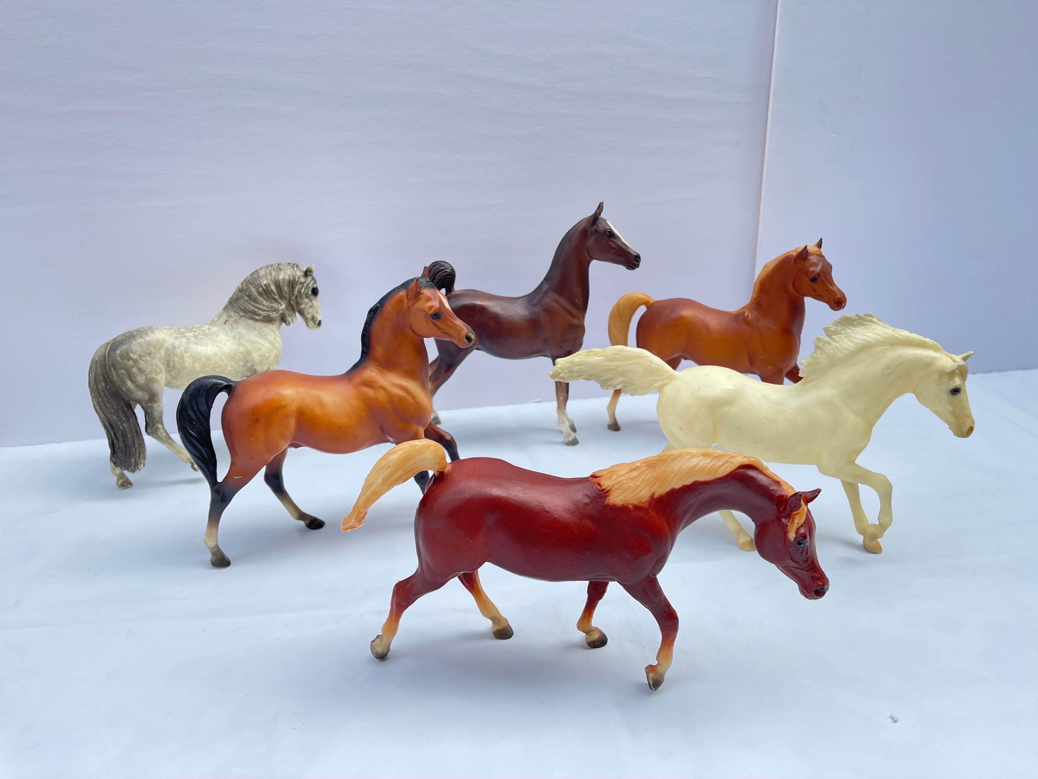 Set of Six Medium Size Vintage Breyer Horses. All Six Breyer horses are stamped . The set consists of four brown toned horses and two whiter toned horses, one having appaloosa spots. Sizes vary by inches. Not all are exactly the same dimension.