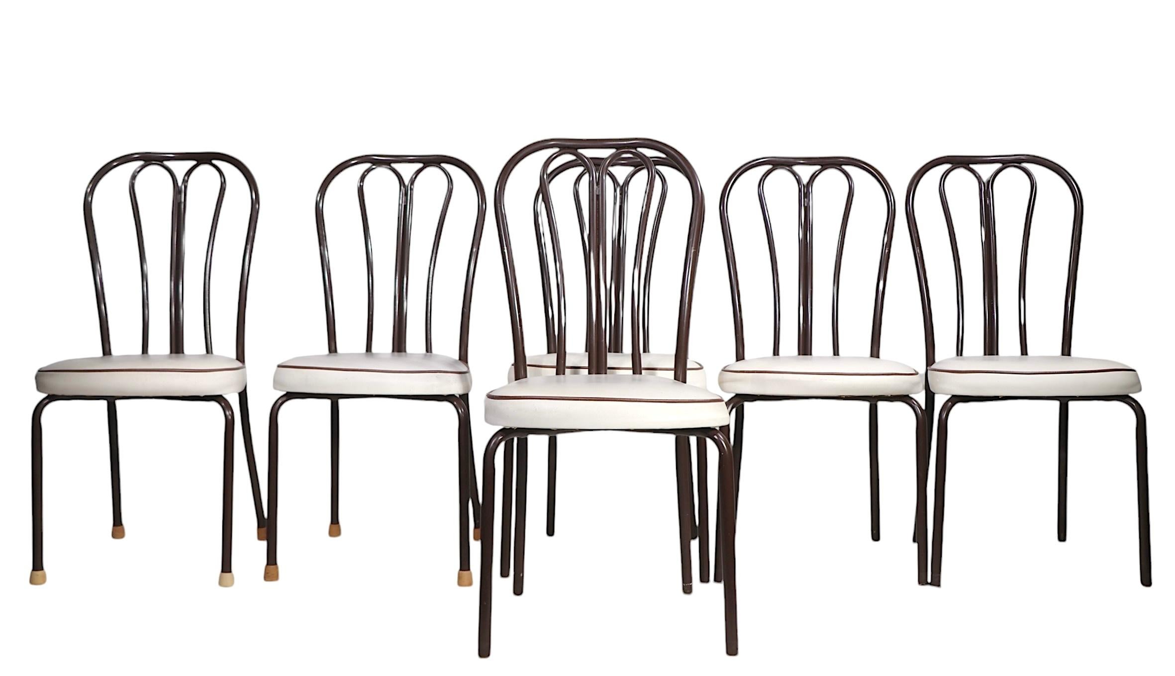 Chic set of vintage 1970's kitchen chairs, modeled after the iconic Vienna Secessionist Thonet originals. The chairs feature tubular metal frames, in brown paint finish, with upholstered pad seats in white with brown piping. 
 Made in the USA, circa