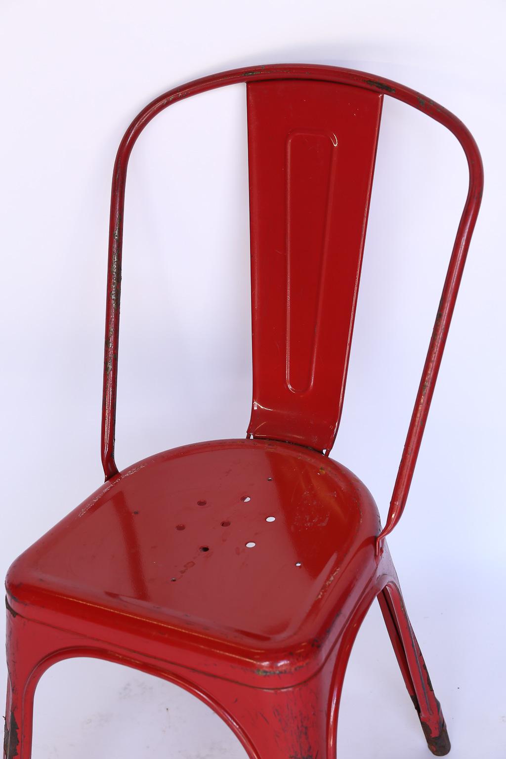 This is a set of six French bistro chairs manufactured by Tolix. The chairs are stackable and light for easy storage. The original red paint is peeling in places and could be stripped to the metal finish or repainted. This is a great set for indoor