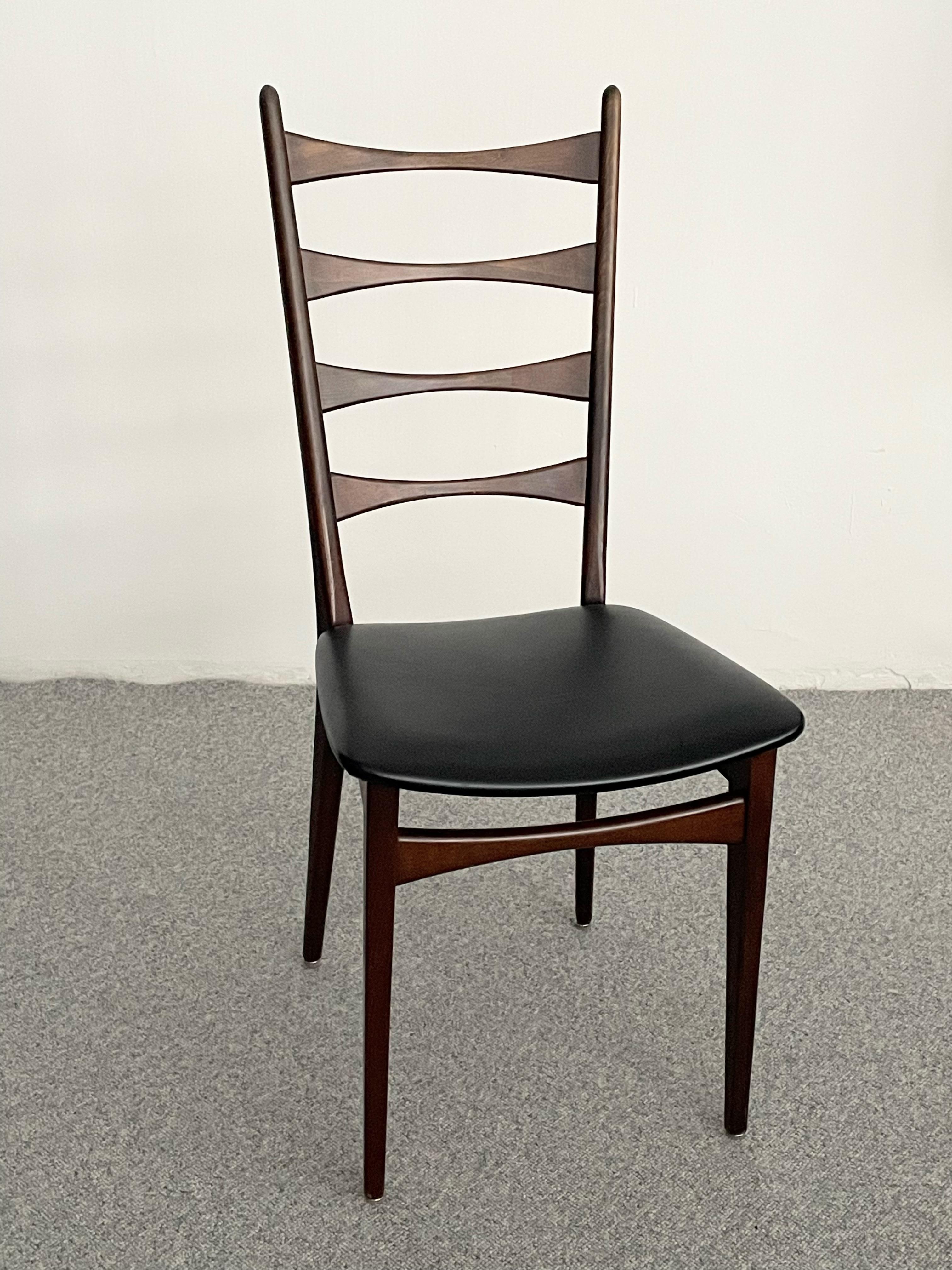 Set of six Mid-Century Modern Dining Chairs that have slatted bowtie design backs, solid wood bases and Faux leather covered seats. The high back provides comfort while giving an unique, clean stylish design. Overall Great Condition a few very tiny