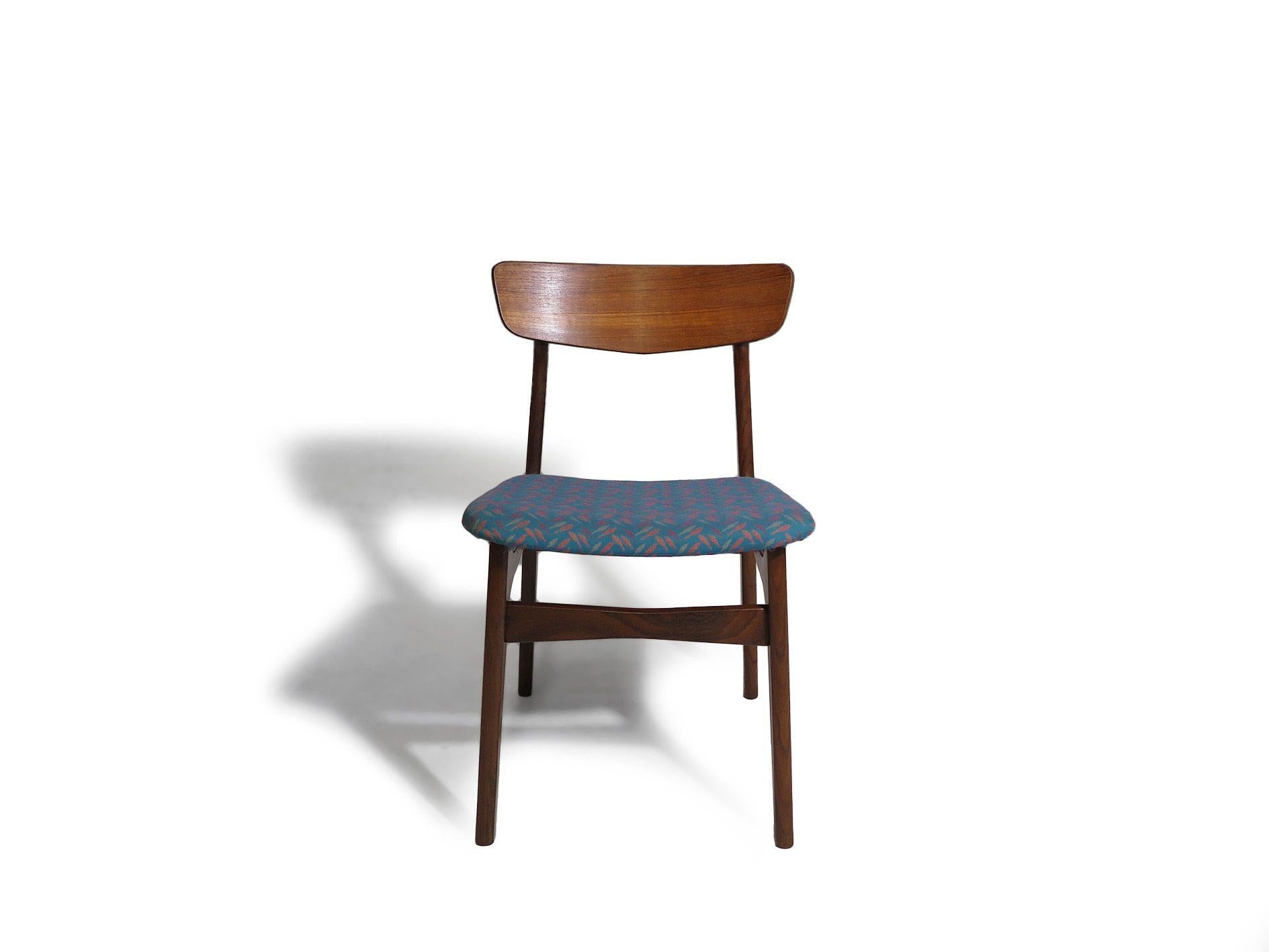 Set of six mid-century Danish dining chairs crafted of old-growth teak with sculpted backrests and floating seats supported by brass risers. The seats are upholstered in vintage textile and ready for new upholstery. The wood has been professionally