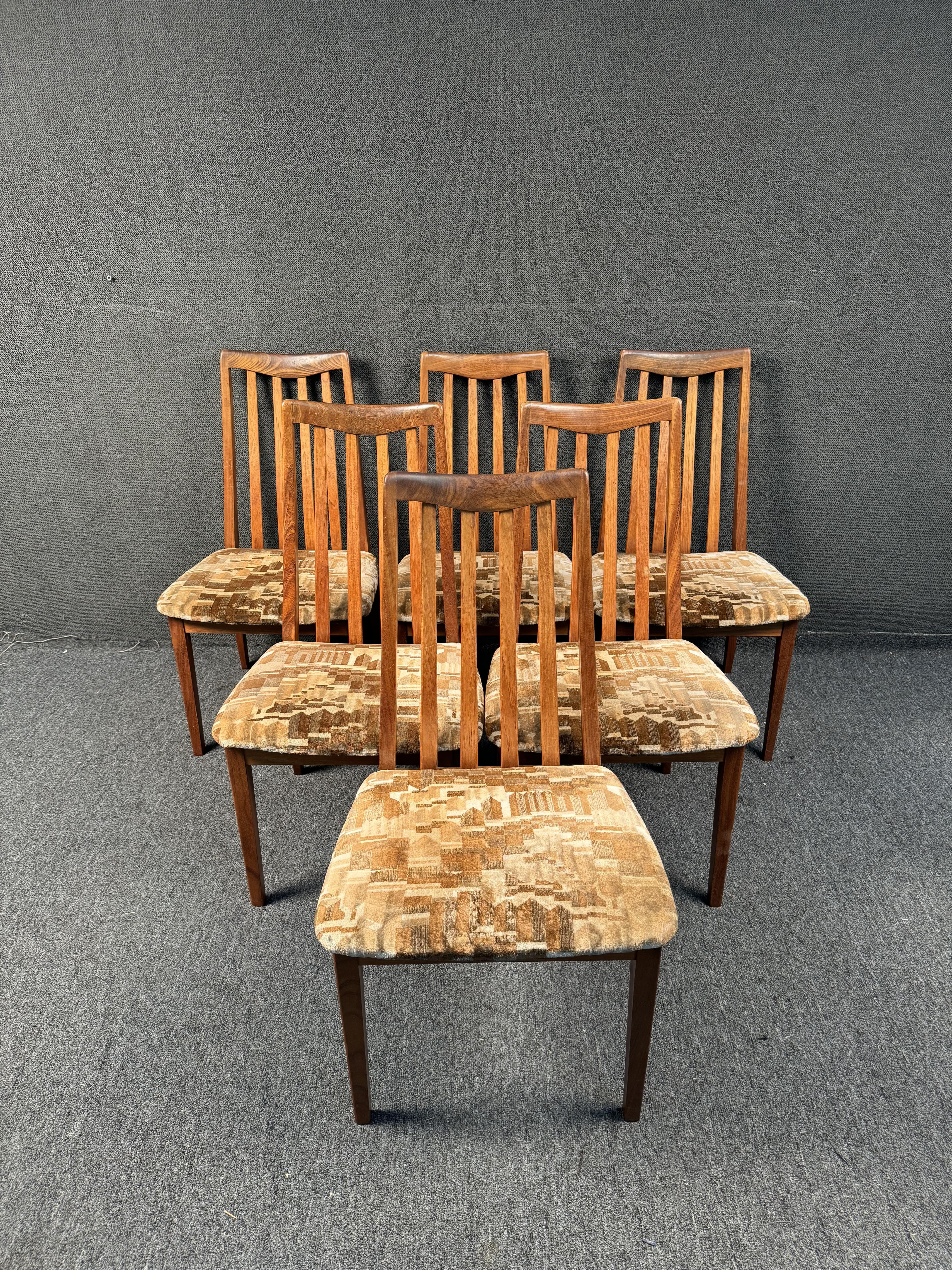 Made in the UK by G-Plan. These MCM dining chairs feature gorgeous wood grain frames, sculpted backs and comfortable seats. Perfect choice to complement your vintage dining table! Please confirm location with seller (NY or NJ)
