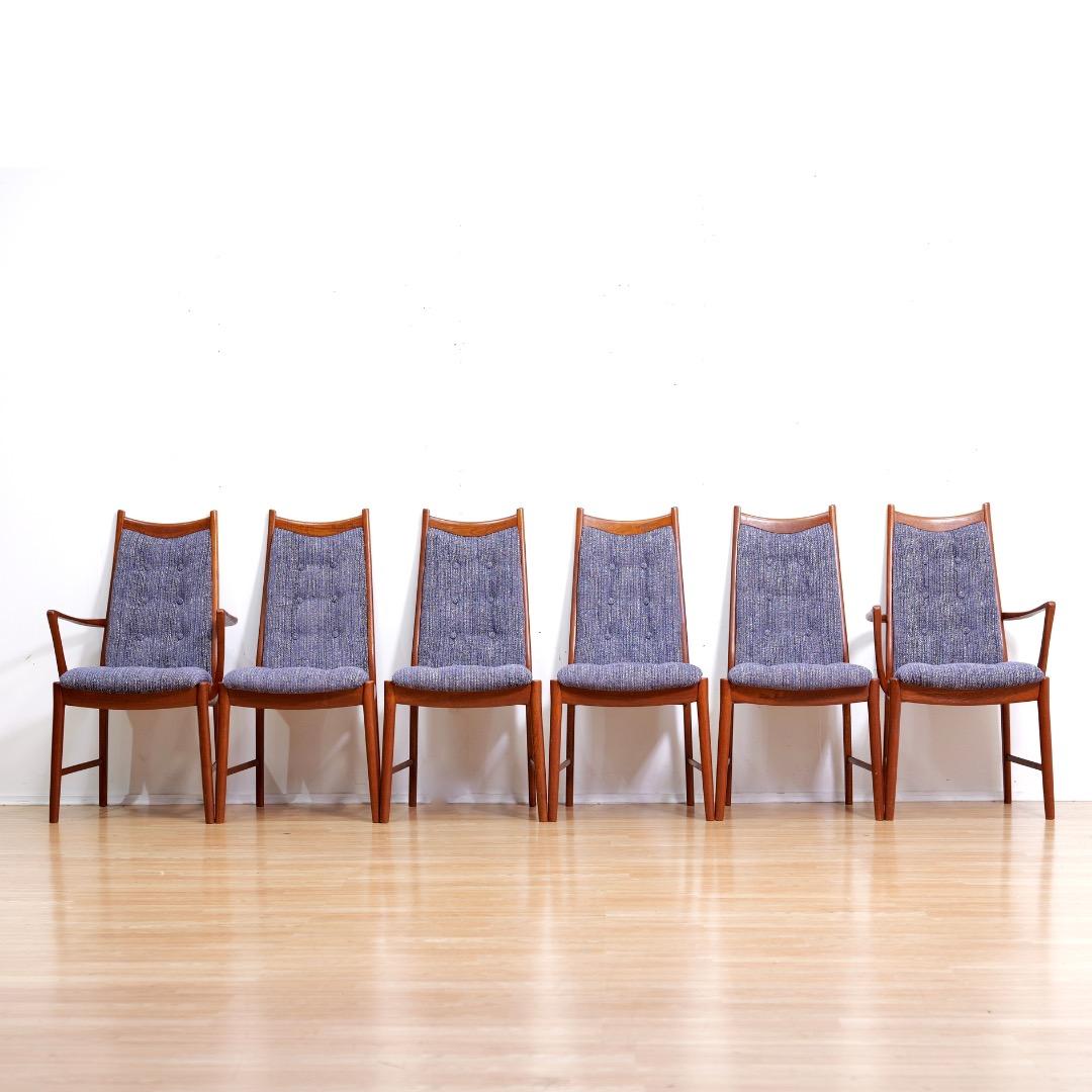 This vintage set of six dining chairs were produced by McIntosh of Kirkcaldy in Scotland 1970. Produced in teak with tufted seats and back rests they are a striking set with four regular chairs and two carvers. They have been fully reupholstered