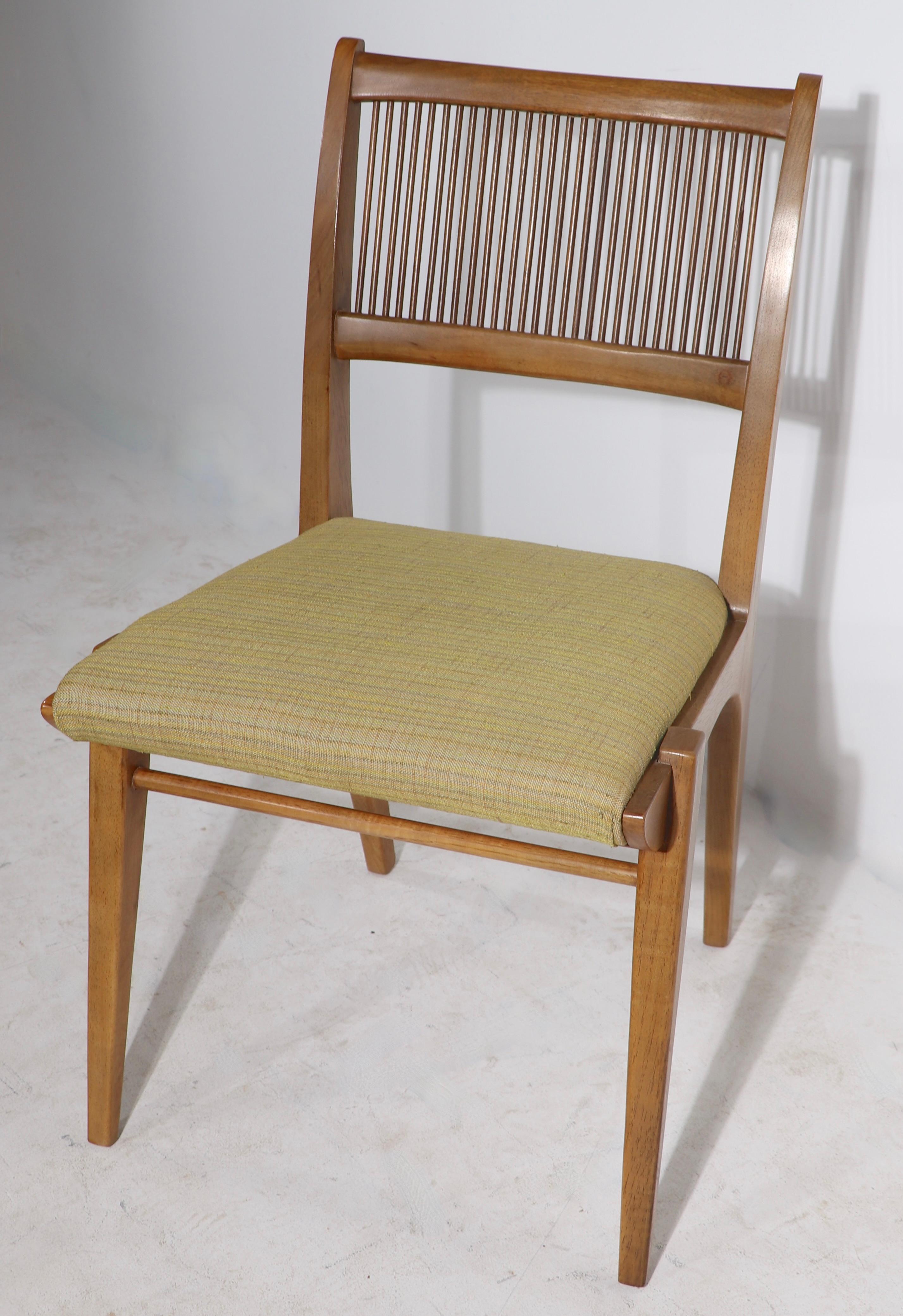 Exquisite set of mid century dining chairs, designed by John Van Koert for the classic Profile series, made by Drexel. Circa 1950's ( 1957 ) the chairs feature a sculpted frame of solid walnut, with spindle backs, and upholstered seats. The set