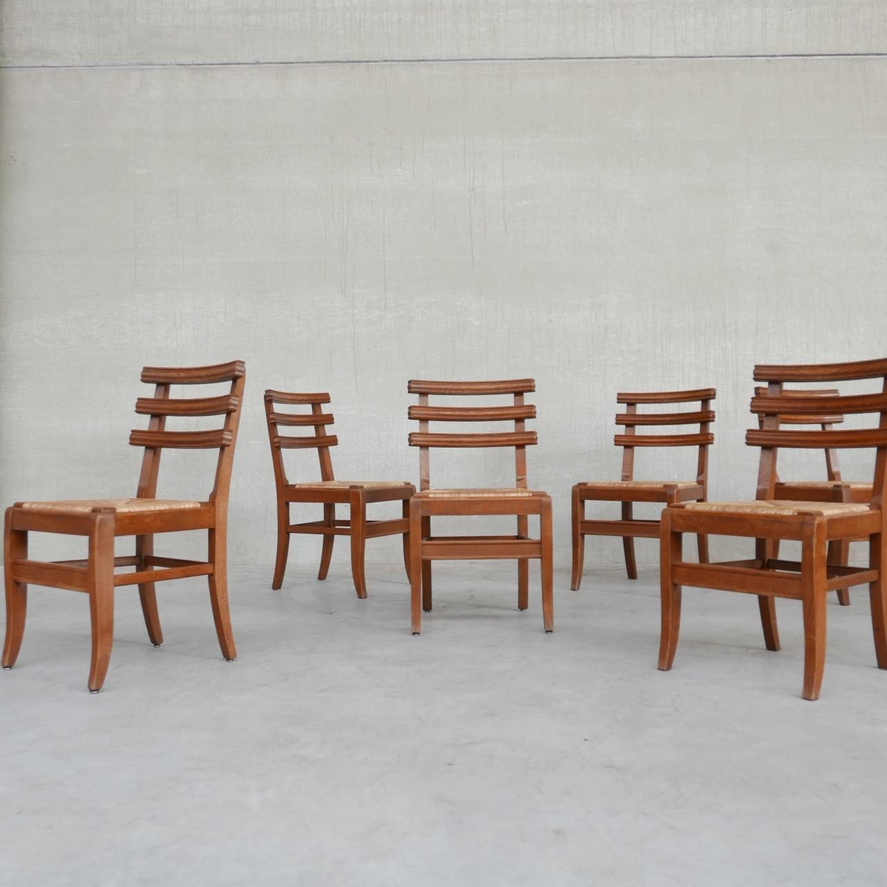 A good quality set of six dining chairs. 

France, circa 1950s. 

Three straps of curved wood to the backs. 

Rush seats. 

An unusual model we haven't seen before. 

The curved backs make them comfy and stylish.

Location: Belgium