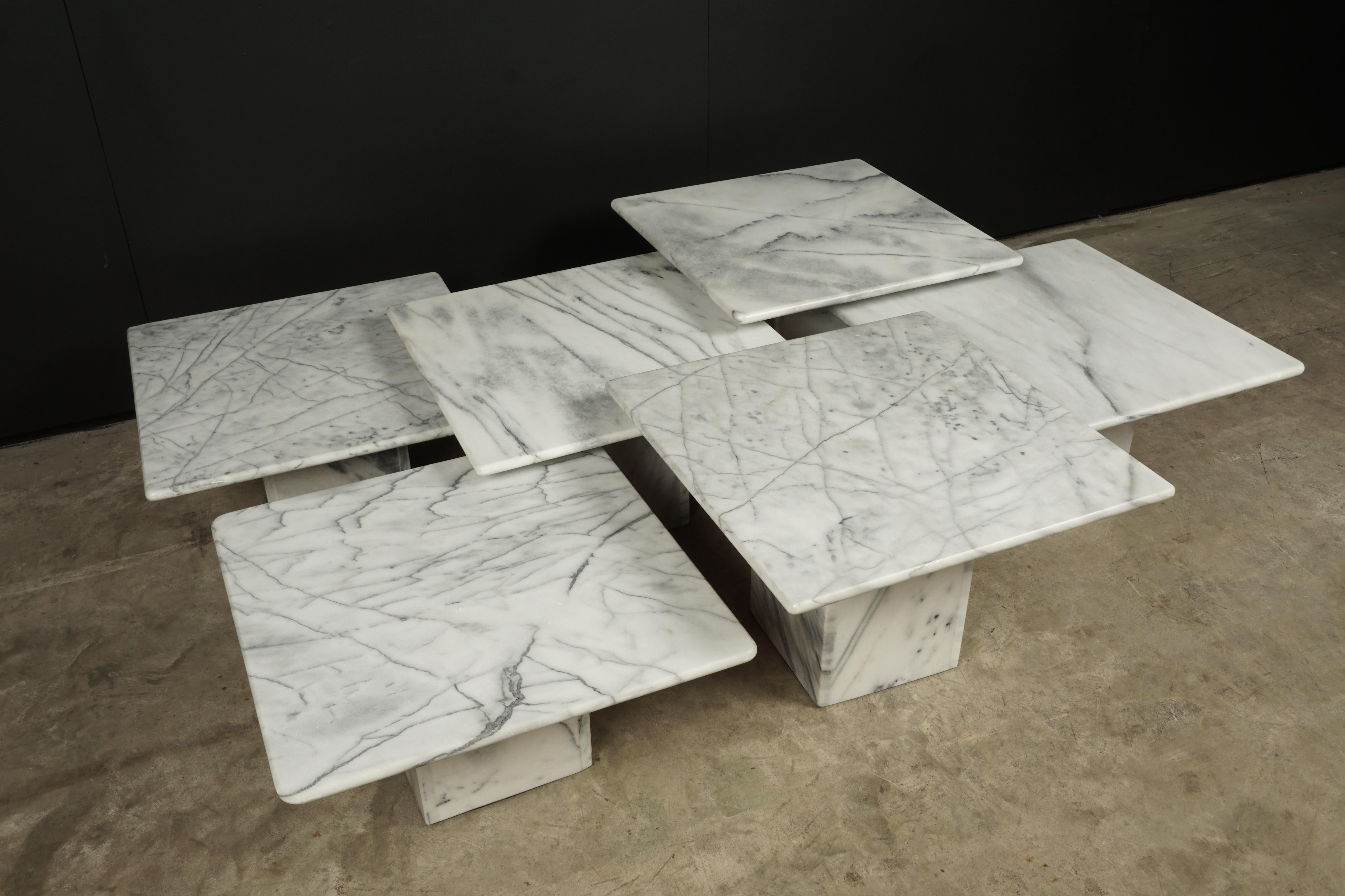 Set of six midcentury marble tables from France, circa 1970. White marble with light wear and use. The heights range between 12