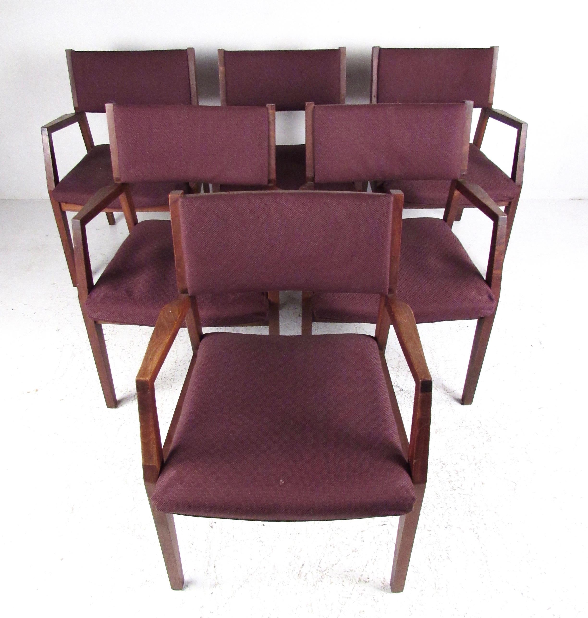 This set of stylish Mid-Century Modern armchairs feature spacious sturdy seats and hardwood frames. Upholstered seats and backs are comfortably padded while the vintage walnut finish makes a Classic vintage modern addition to home or business