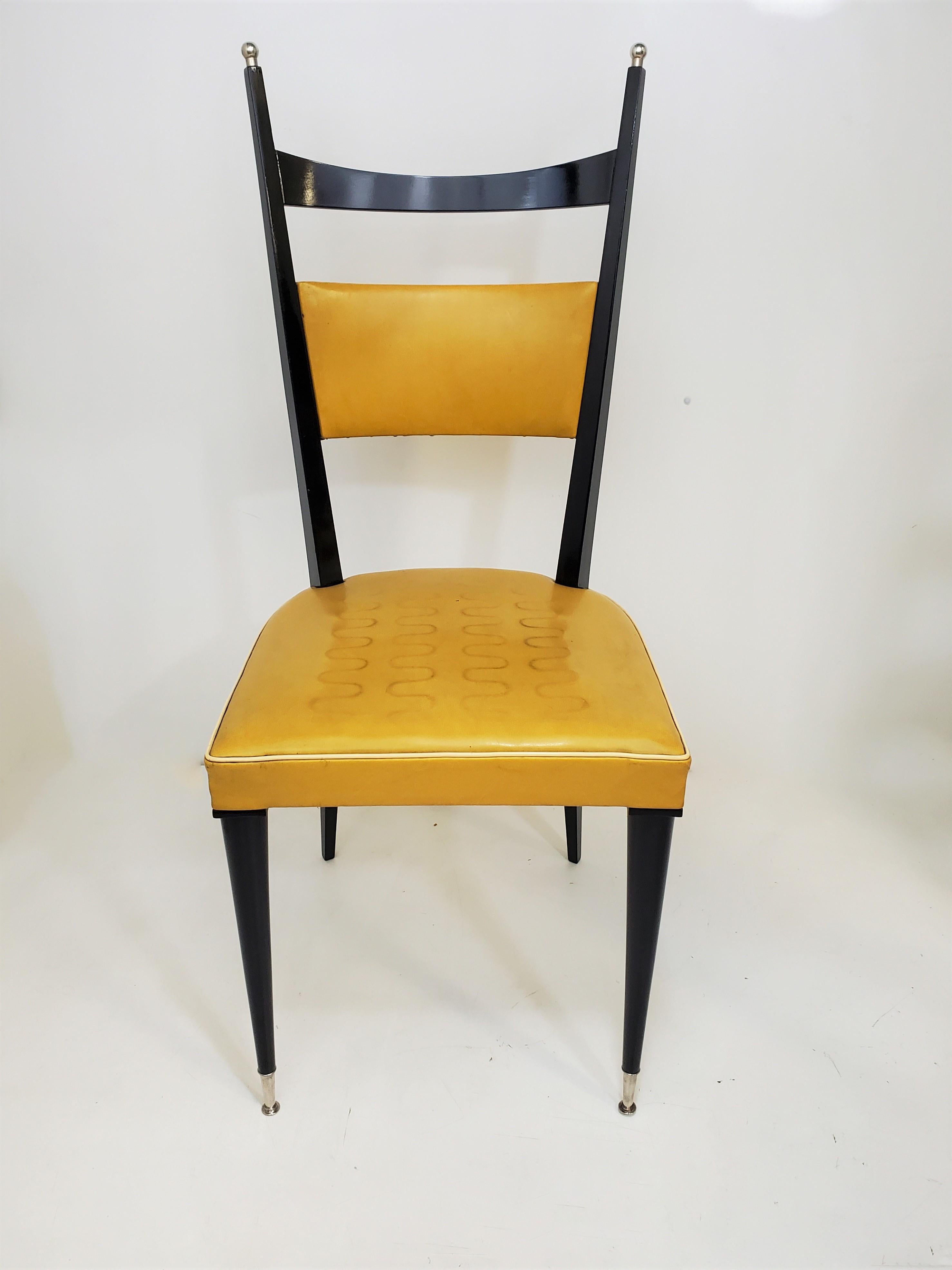 A lovely set of six original French Modernist dining chairs featuring tall backs with horizontal swag and vertical posts ending in nickeled ball tips and matching nickeled sabots on front two feet. 
The open airy design create aesthetic and