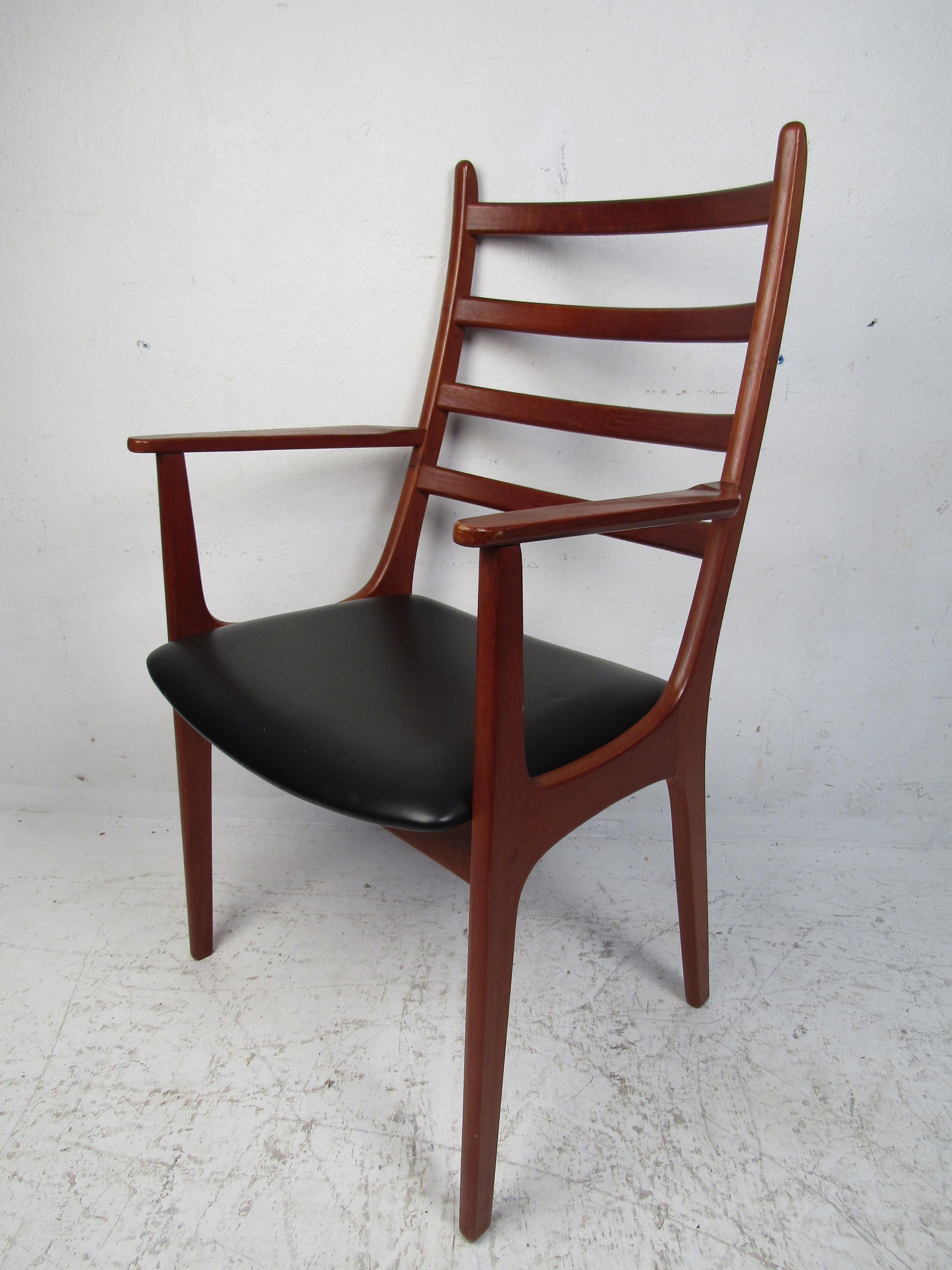 This stunning set of six Danish modern dining chairs boast a ladder backrest and a black vinyl seat. A sturdy frame that ensures comfort with rich teak wood grain. This set includes two armchairs and four slipper chairs. The perfect addition to any