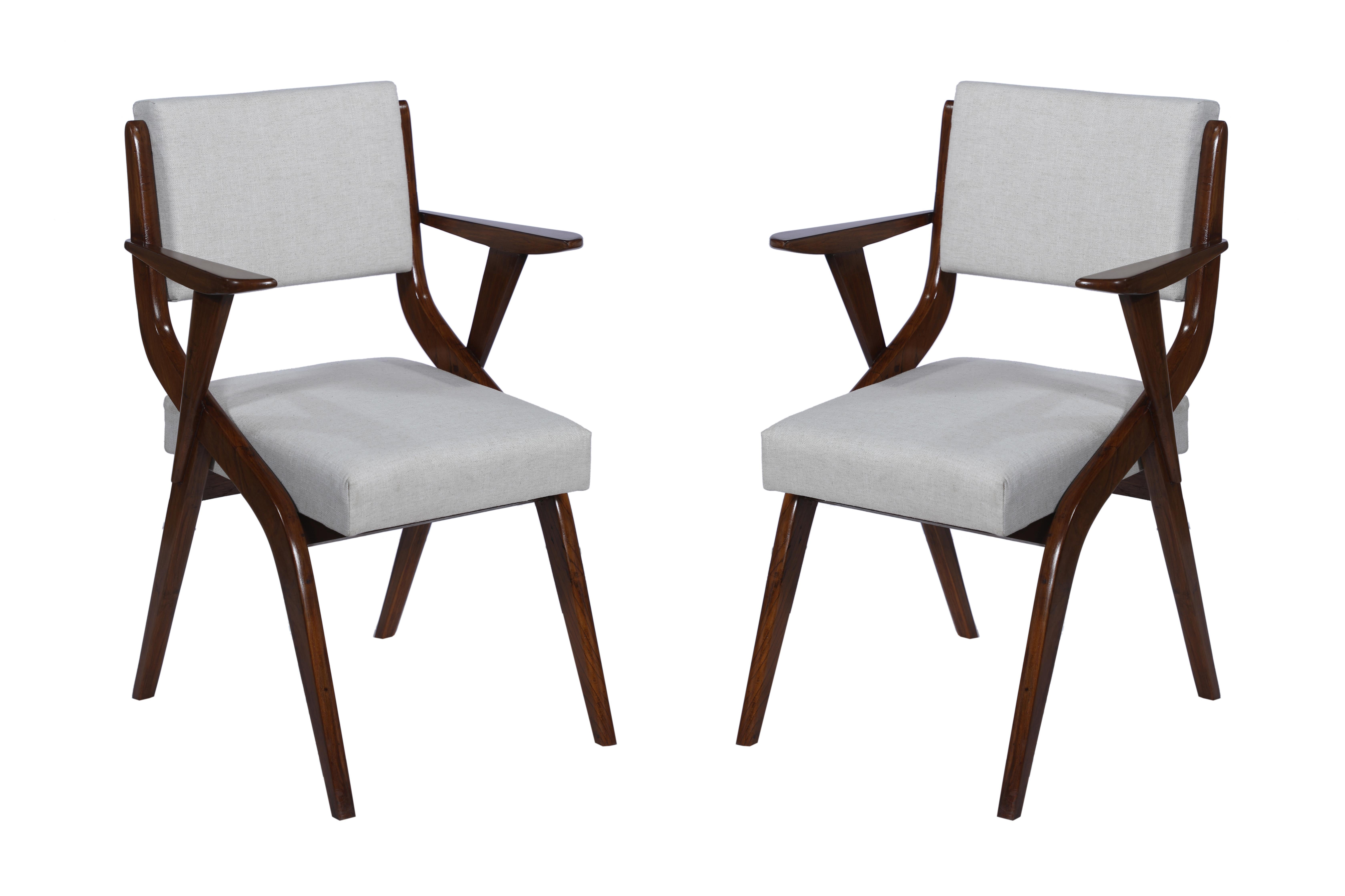 A handsome set of six Danish, Mid-Century Modern teak dining chairs with arm rests. They have been reupholstered and refinished. Fabric is a silk and linen blend with new cushions, and the chairs look great from behind as well. The arm rests are