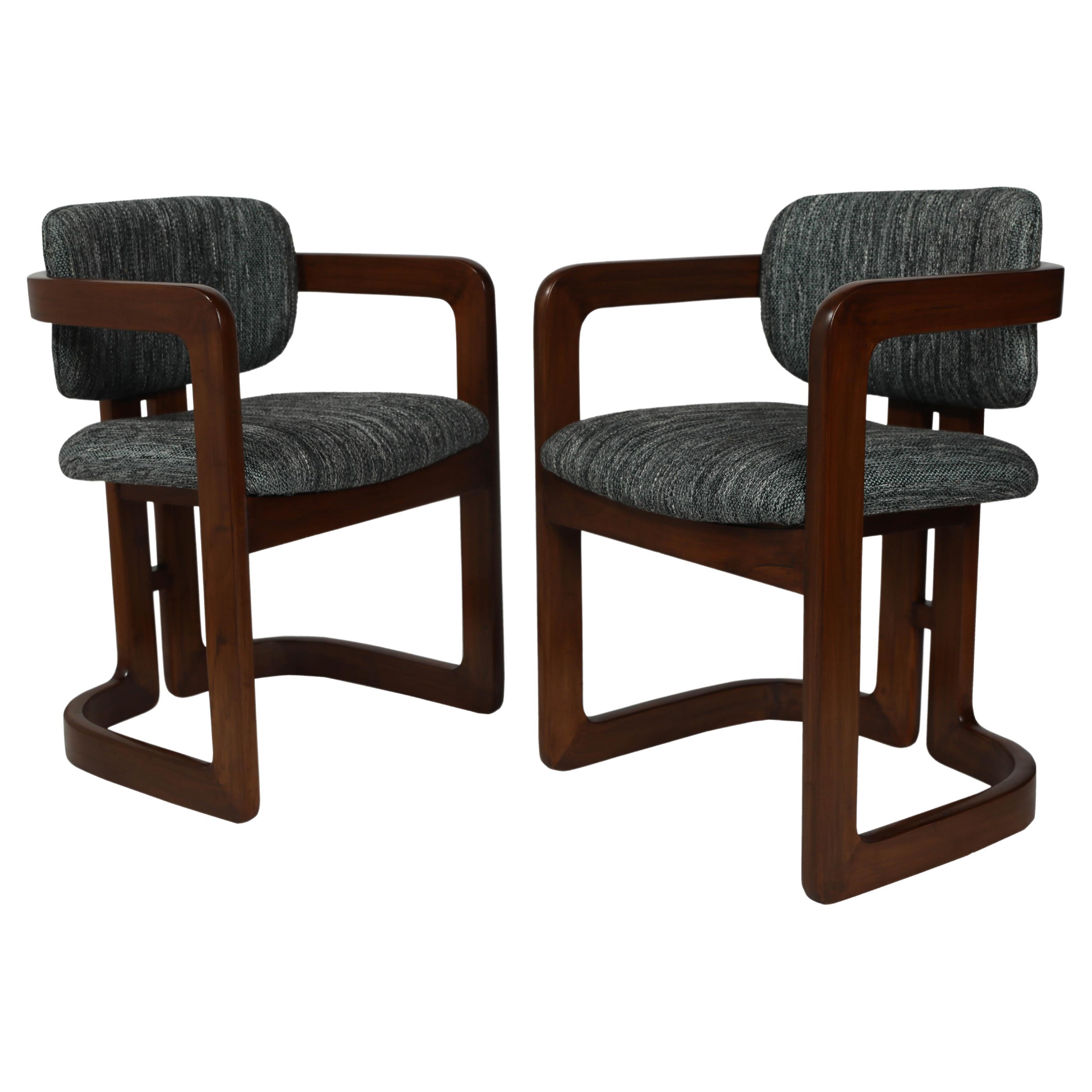 An amazing and elegant set of six Mid-Century Modern Danish teak dining barrel arm chairs. They feature a curved back , a U-shaped base with a stylish double-back support. The seat cushions and cushioned back rest have been replaced and