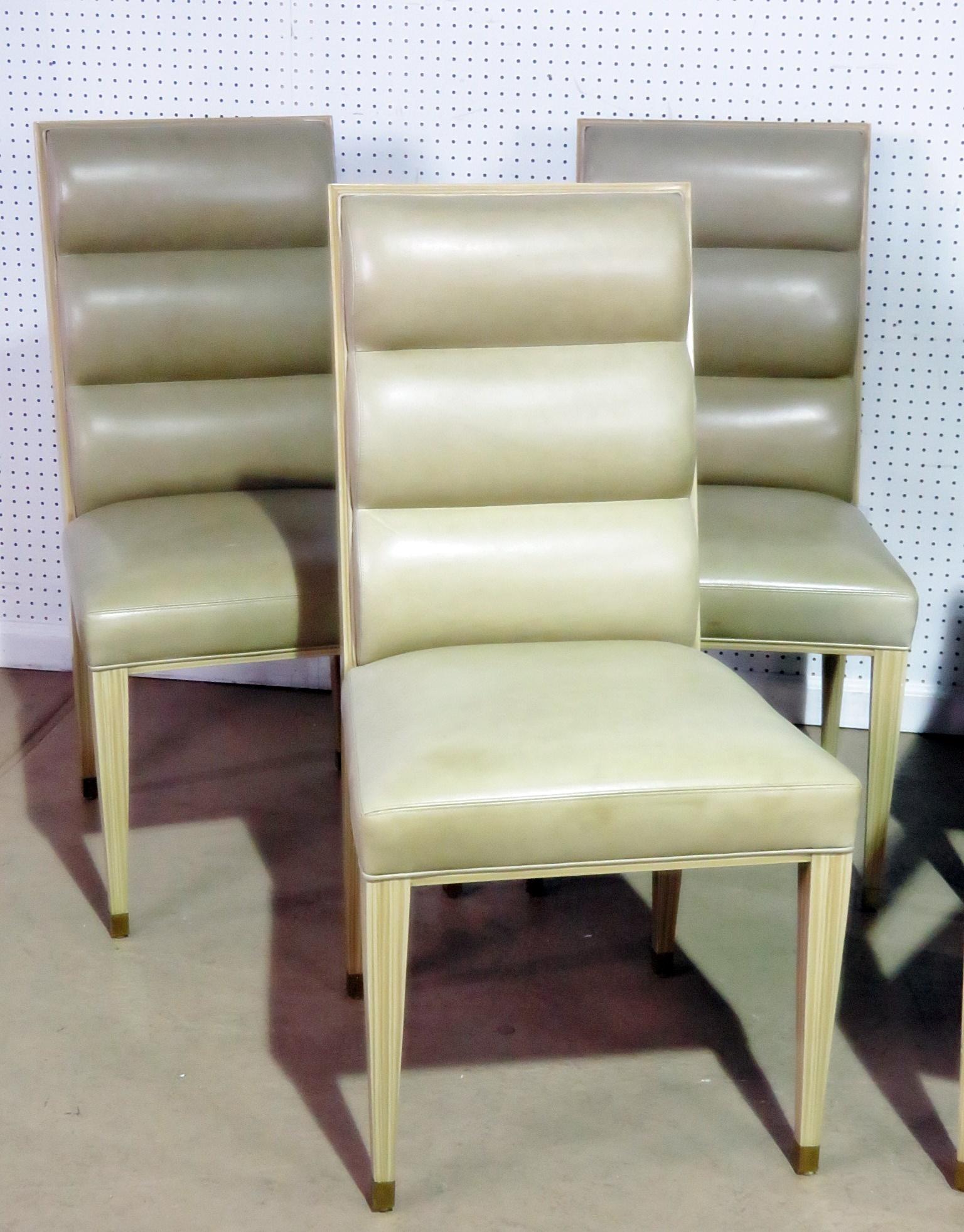 Set of six Mid-Century Modern dining chairs with leather upholstery. Two armchairs measure 29