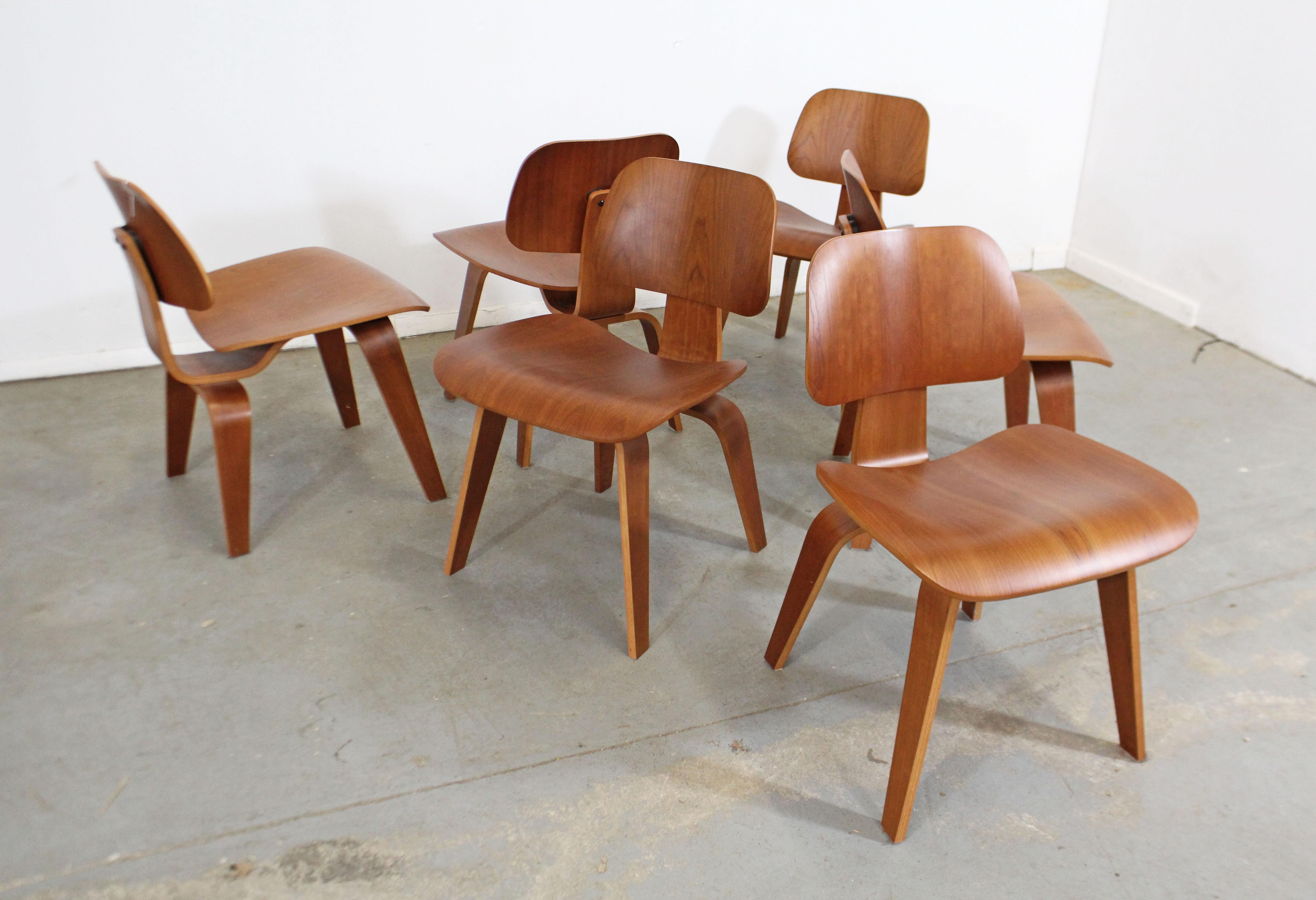 What a find. Offered is a very cool set of six Mid-Century Modern dining chairs, designed by Eames for Herman Miller. These chairs are made of molded plywood in a natural cherry finish. Expertly crafted with a molded seat and back, this chair