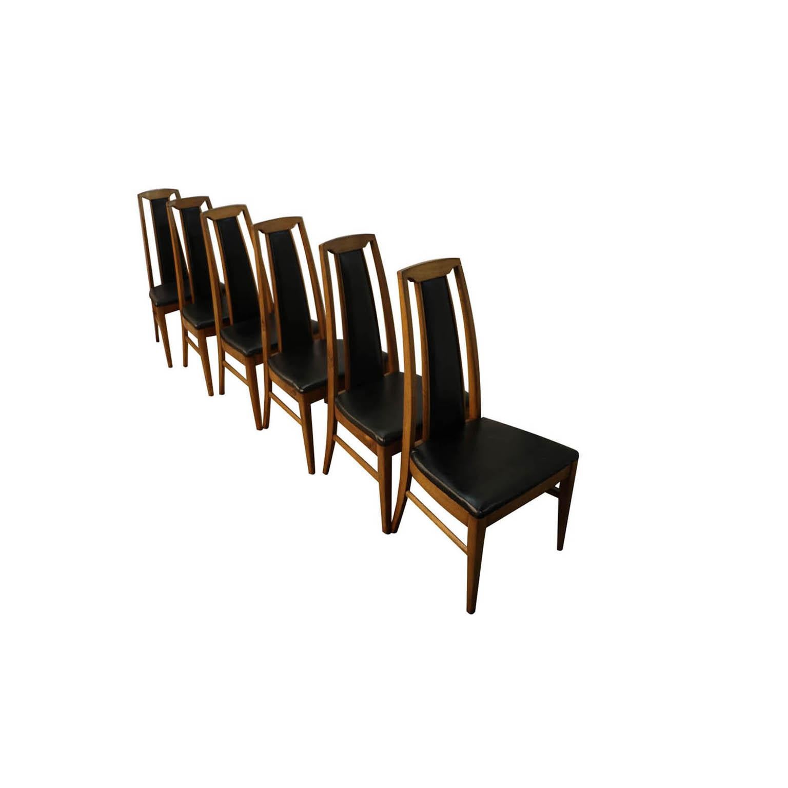 Sophisticated set of six Mid-Century Modern high back dining chairs, circa 1970s, USA. Featuring a striking combination of beautiful walnut wood and high backs with partial black upholstery. The comfortable and supportive high backrests and seats