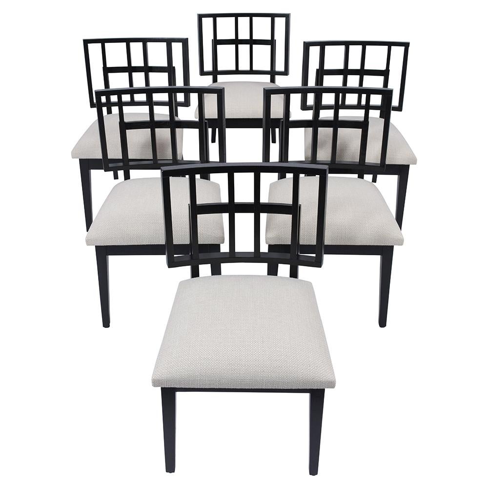 An extraordinary set of six mid-century modern dining room chairs are hand-crafted out of wood and features a unique sleek frame design newly stained in an ebonized color with a satin lacquered finish. This set of side chairs come with a low