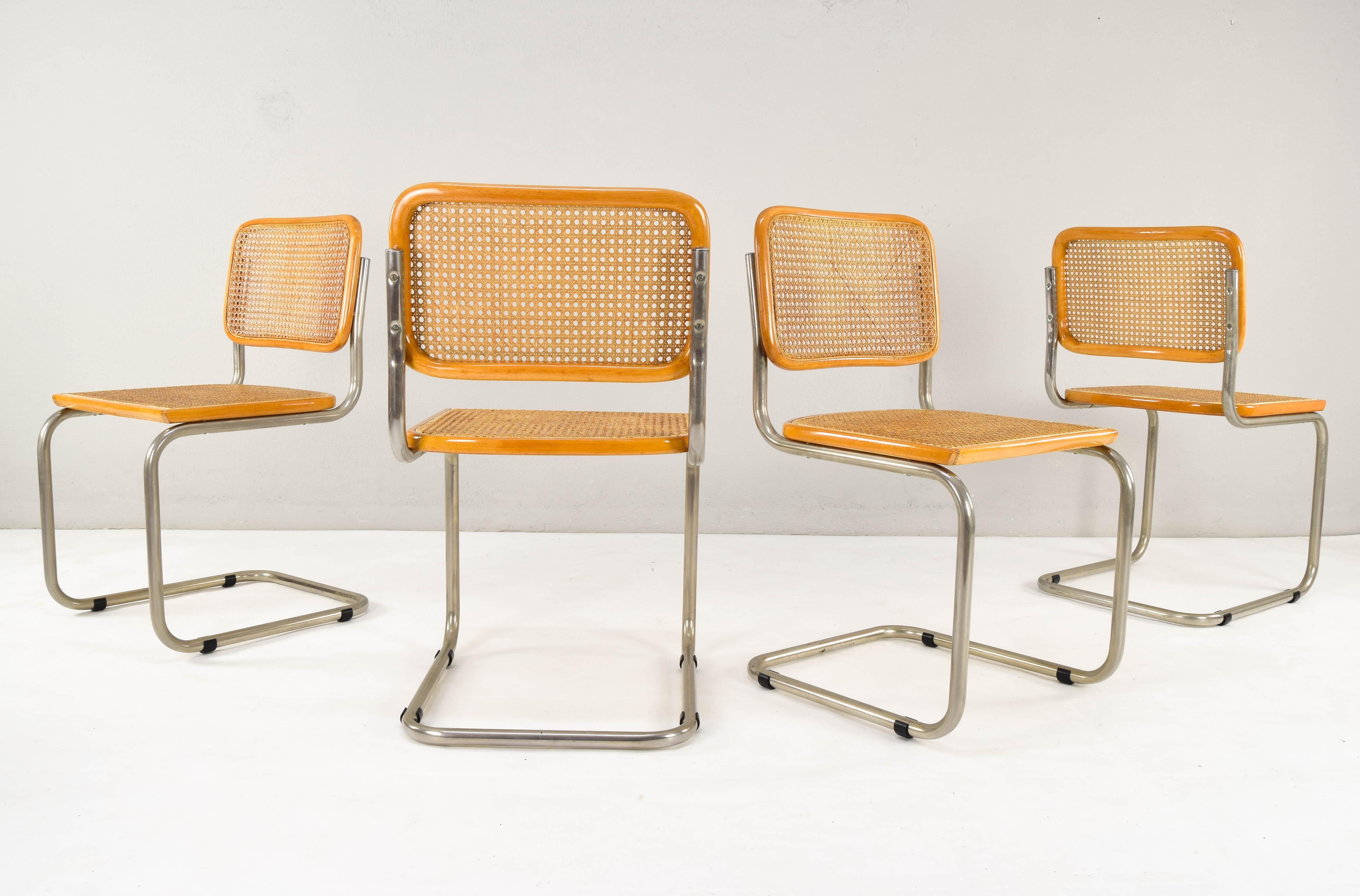 Set of six Cesca chairs, 4 model B32 and two model B64 (whit armest), made in Italy, early 1970s.
Chrome tubular structure with wear areas at the bottom of some of them but in good condition. 
Beech wood frames and Viennese natural grid. The grills