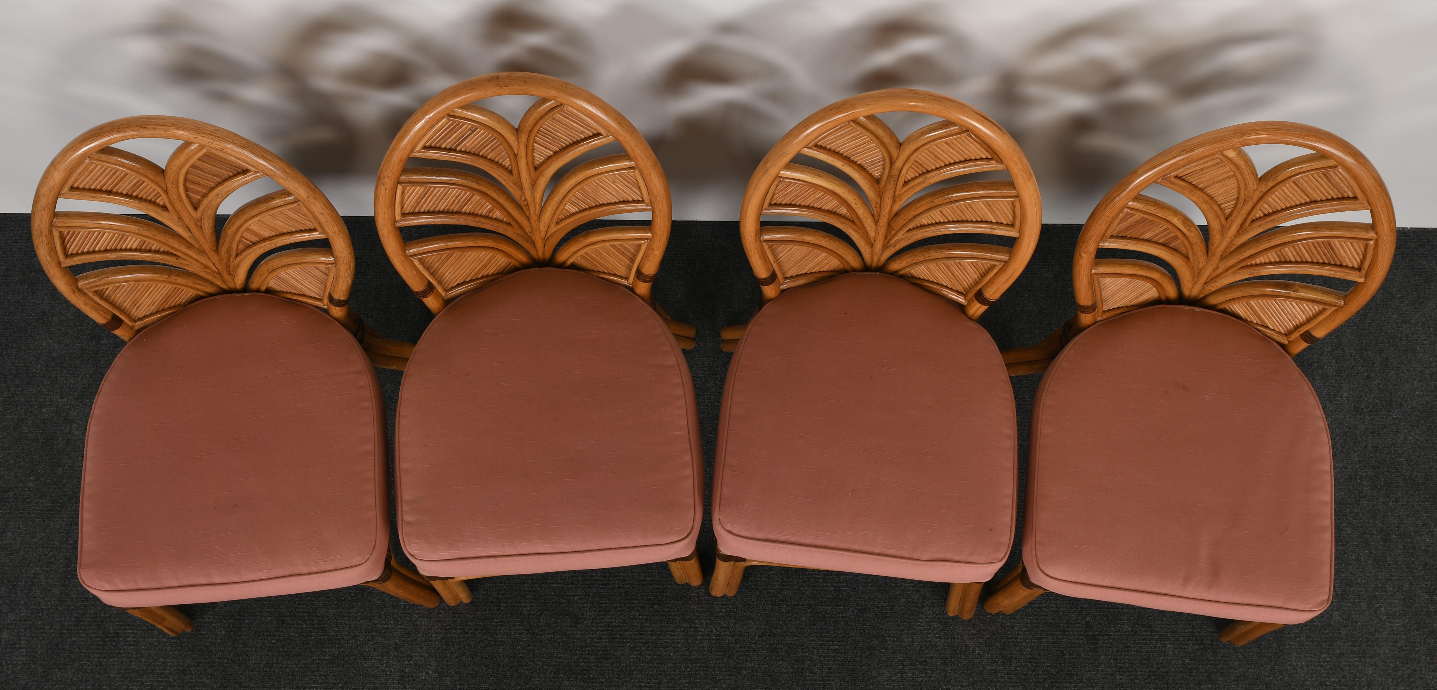 A stylish set of six rattan dining chairs with palm leaf design and leather wrapped detail. Very comfortable and functional. Good condition with age appropriate wear. New upholstery recommended.

Side chair dimensions: 38