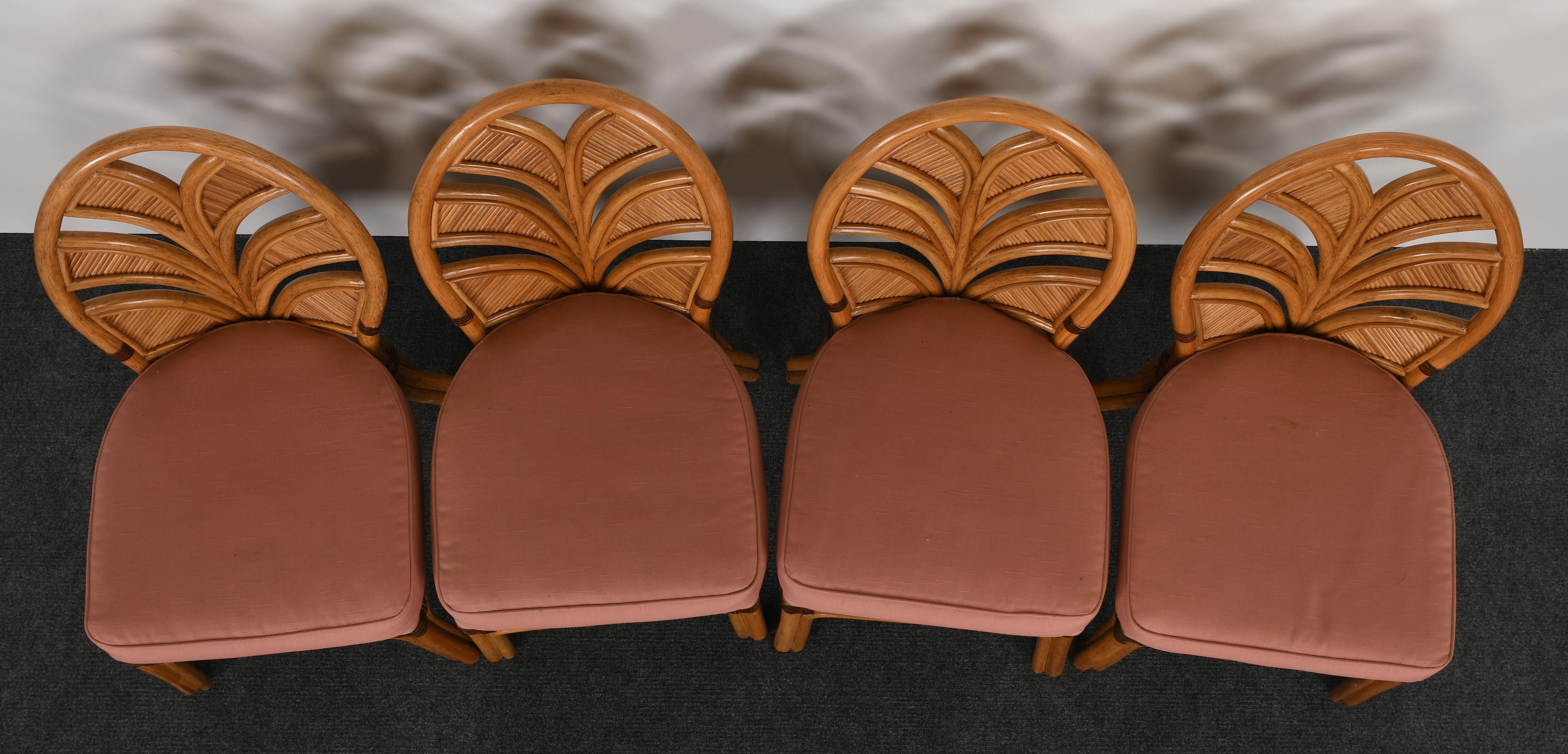 A stylish set of six rattan dining chairs with palm leaf design and leather wrapped detail. Very comfortable and functional. Good condition with age appropriate wear. New upholstery recommended.

Side chair dimensions: 38