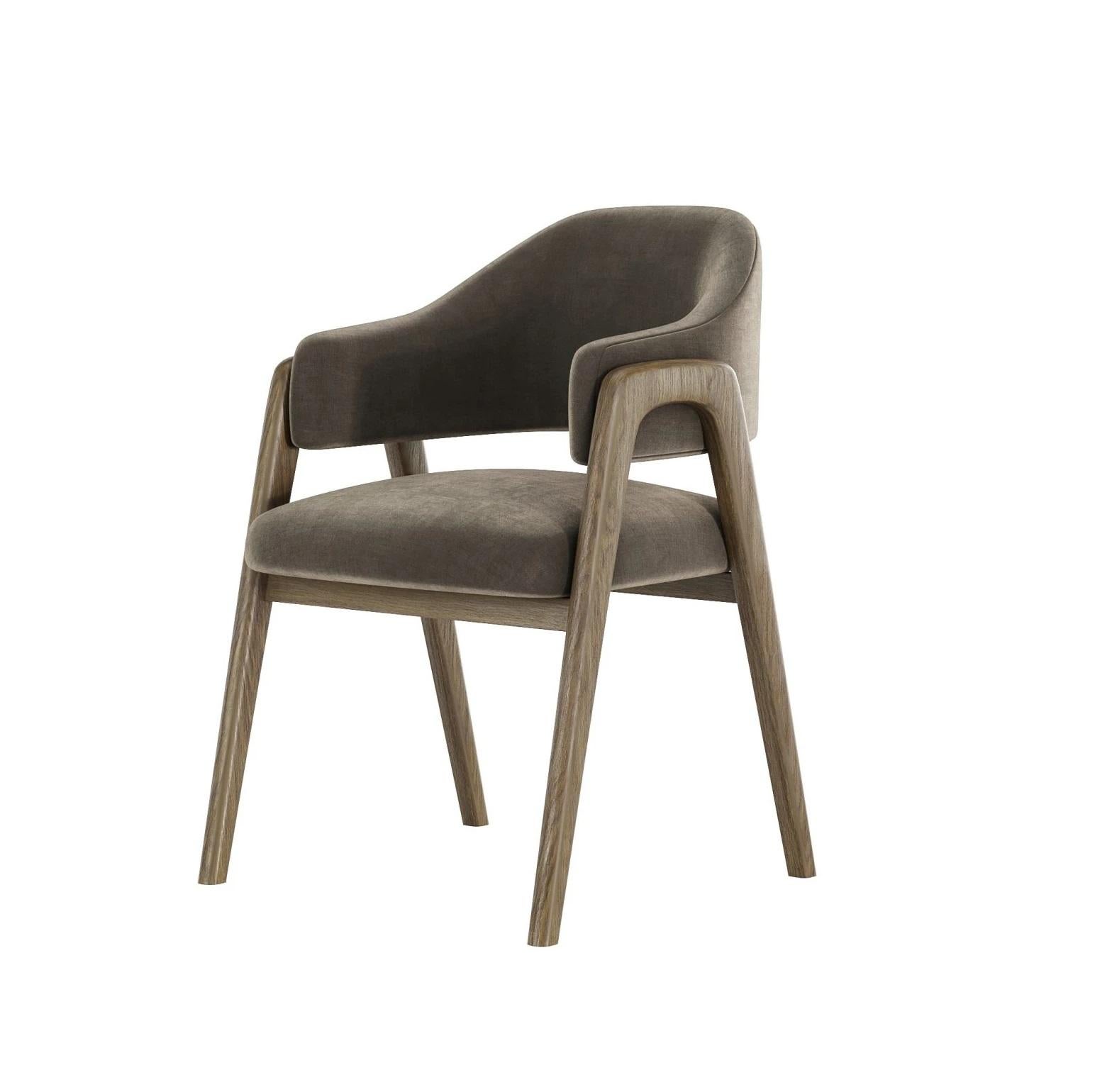 This classic dining chair seamlessly blends comfort and sophisticated design. It features a generously upholstered seat and backrest, providing a plush and inviting seating experience. The chair's legs and gracefully-shaped armrests are crafted from